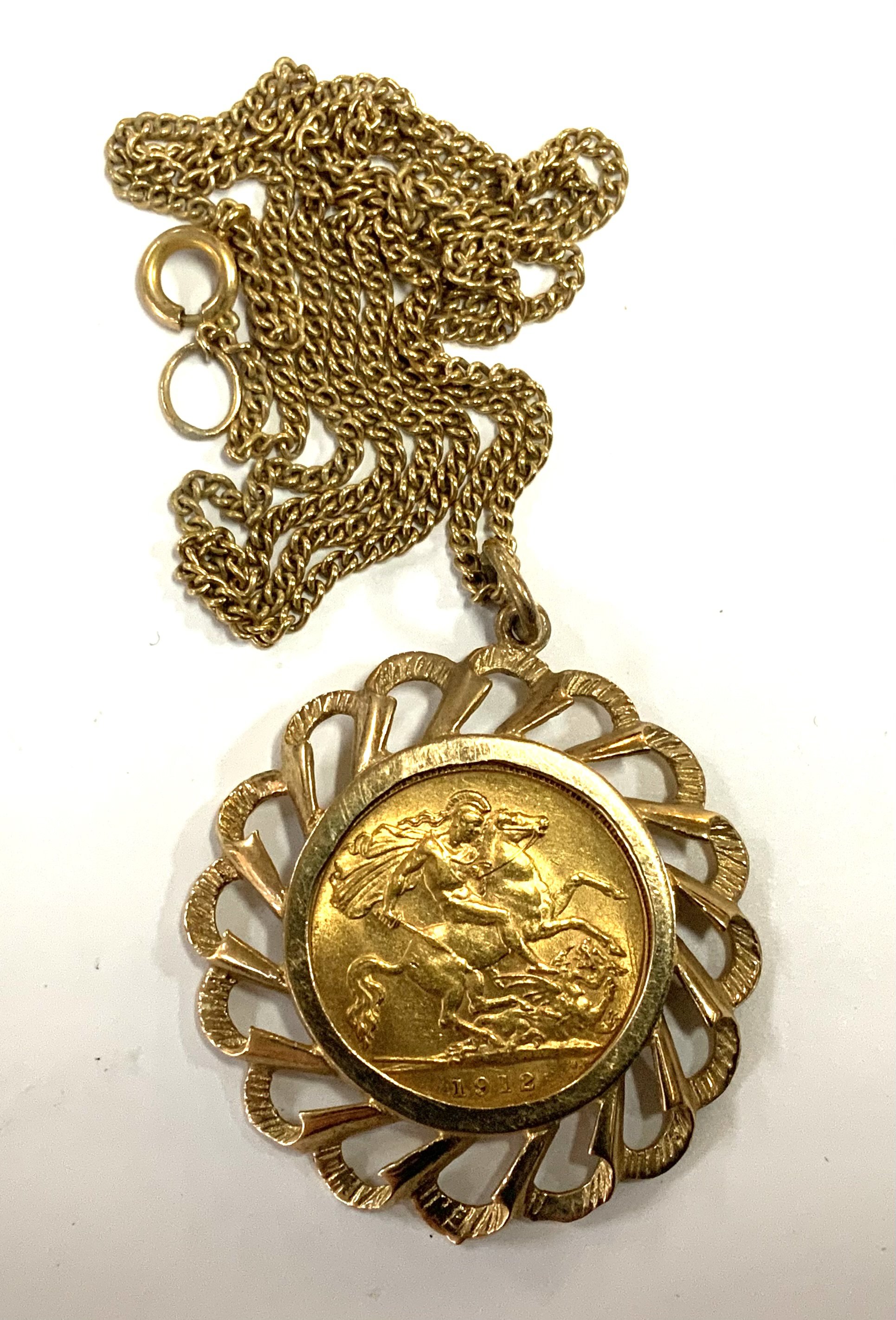 George V, 1912 half sovereign, with 9ct gold mount and chain (11.68g), A.
