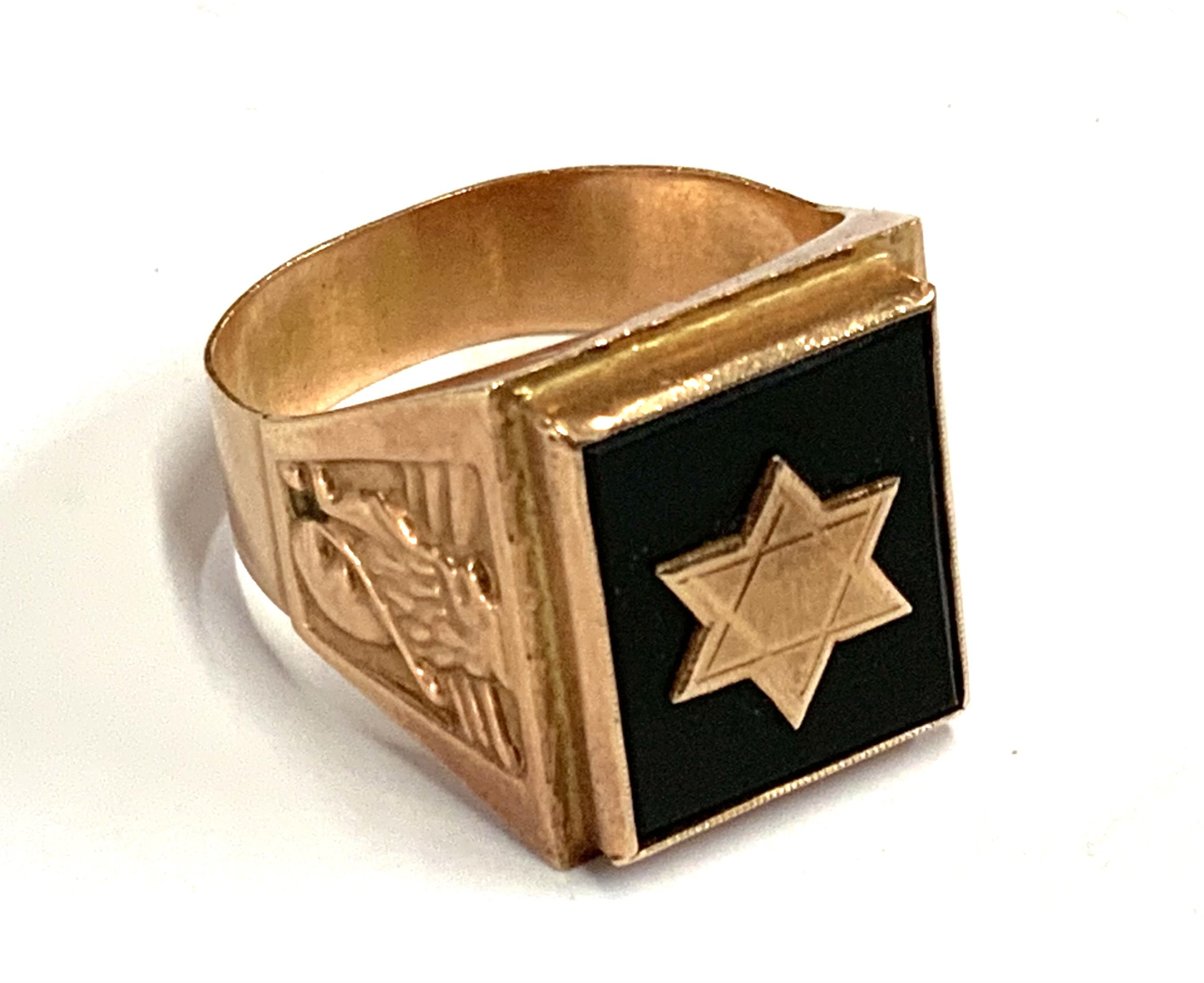 A middle Eastern gold college style ring inset with onyx and a Star of David motif in gold. 7.28g, Size W. (A)