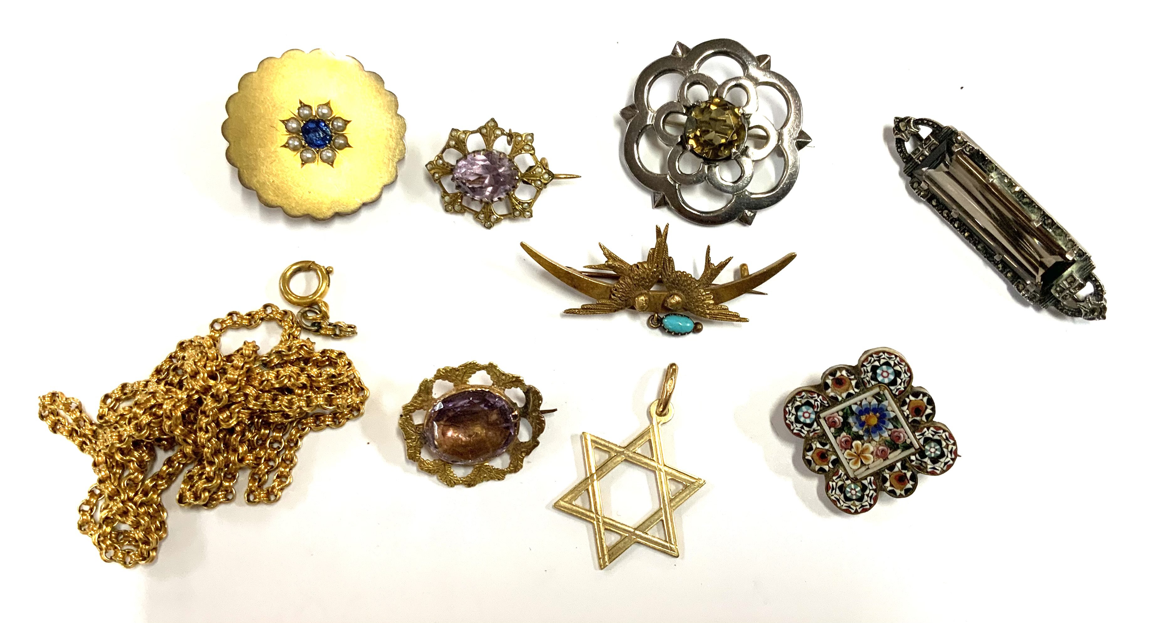 A small collection of vintage silver and yellow metal brooches etc. (A)
