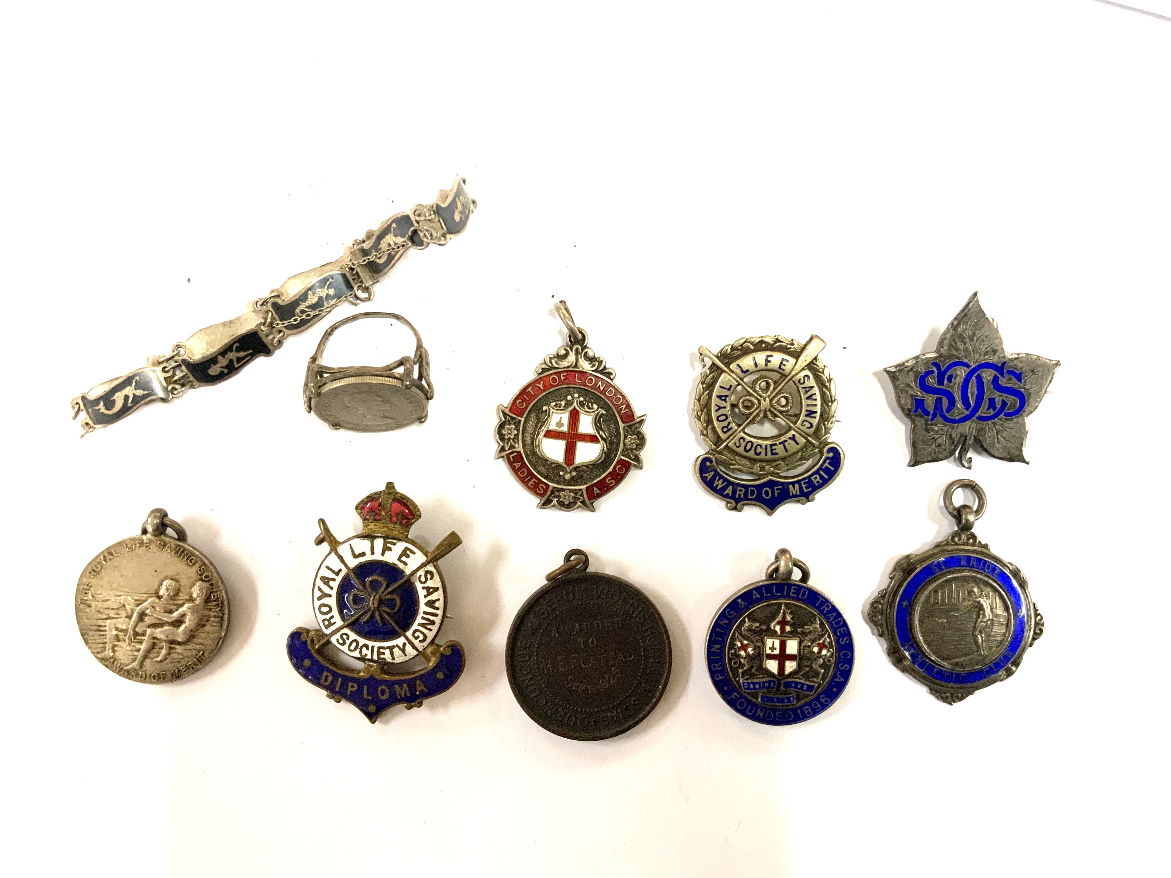 A collection of Royal Life Saving society award badges. (A)