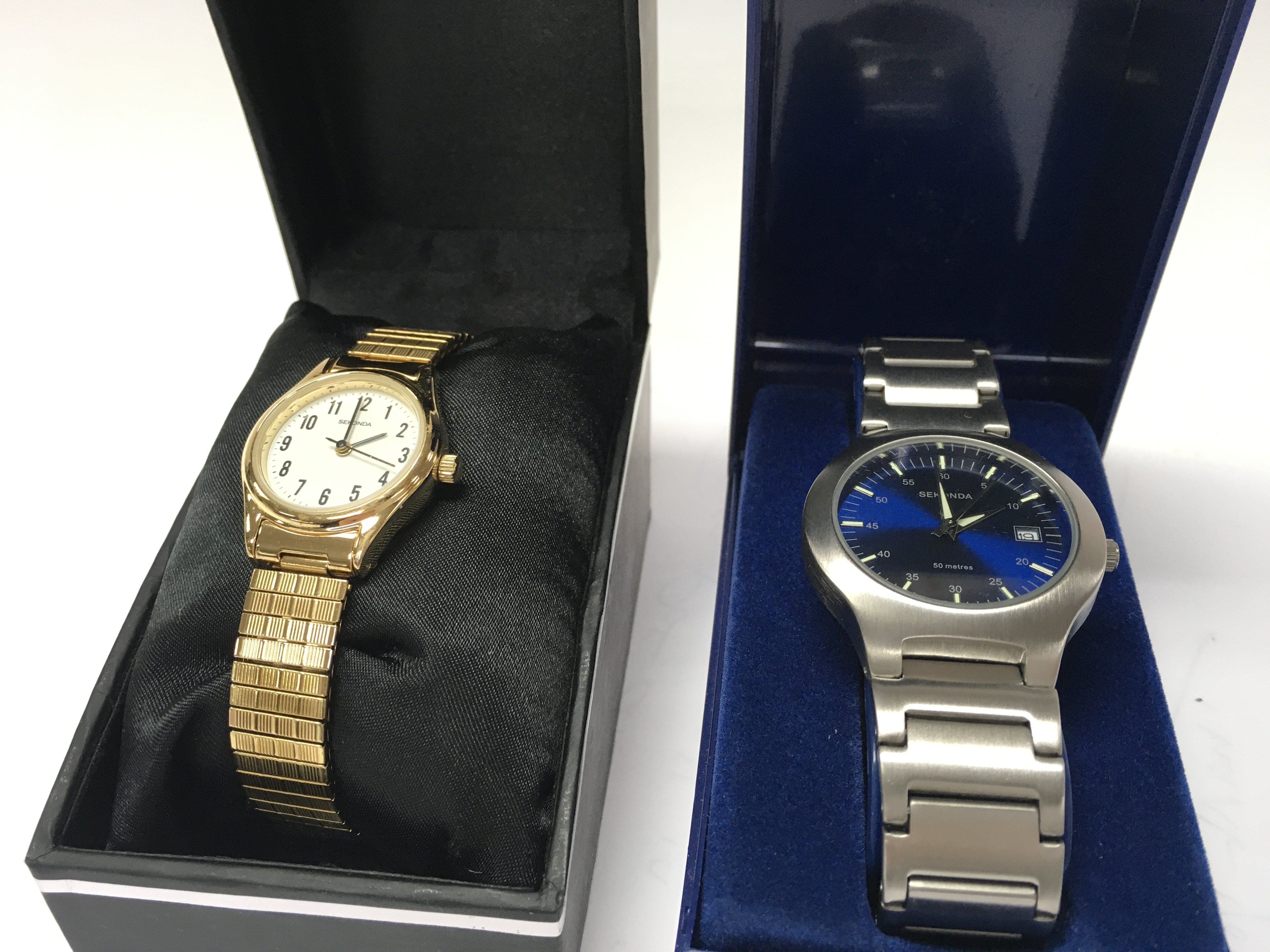 Two boxed Sekonda quartz watches Comprising a mens blue face date watch and a ladies gold tone watch. Postage category B