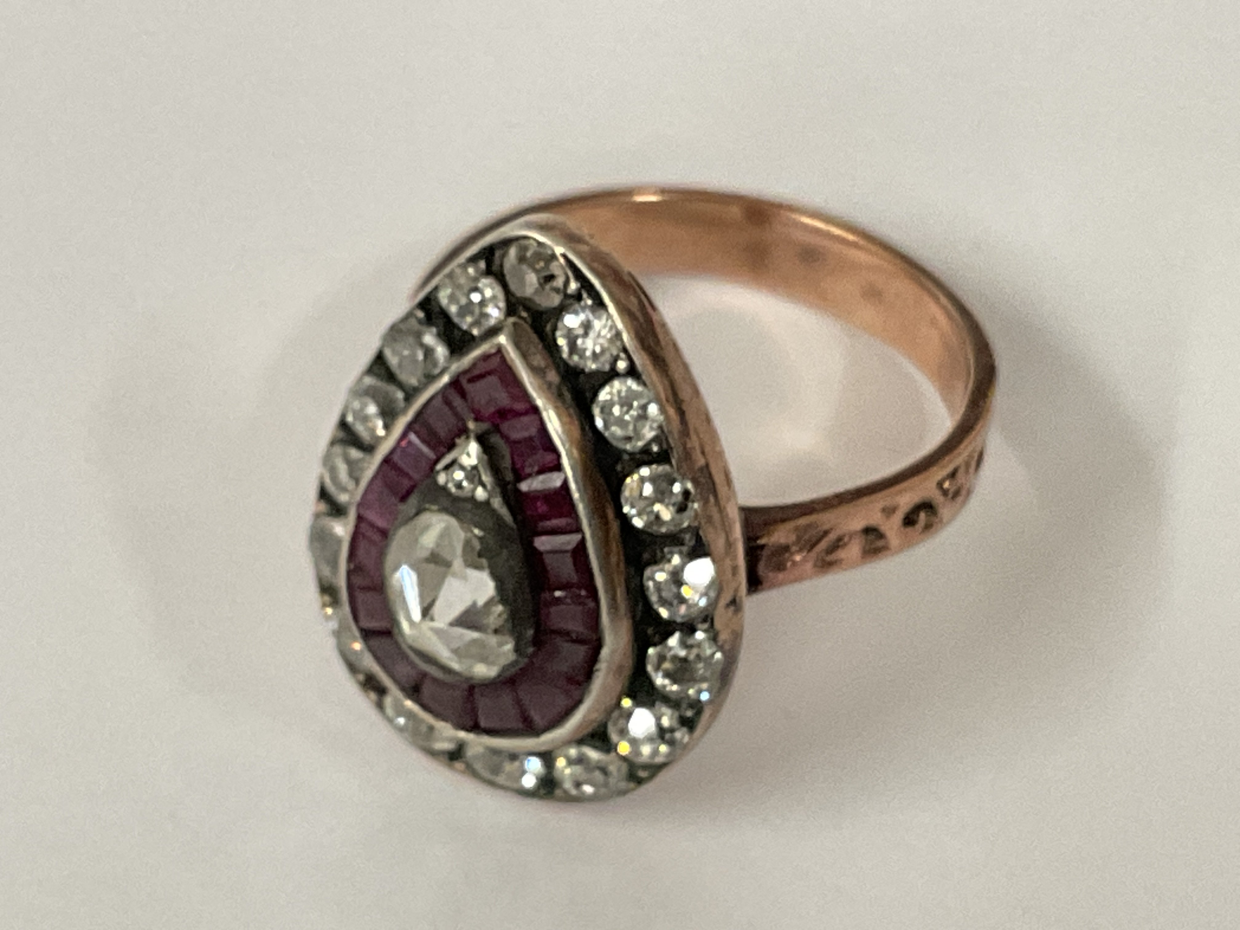 Certificated vintage style 8ct rose gold (silver top) pear shaped ring set with pear shaped rose cut diamond (0.45ct), mixed rectangular cut rubies (0.45ct) and old European cut diamonds (0.80ct). Cert no. WG19624144935. Approx ring size L/M. Postage category A.