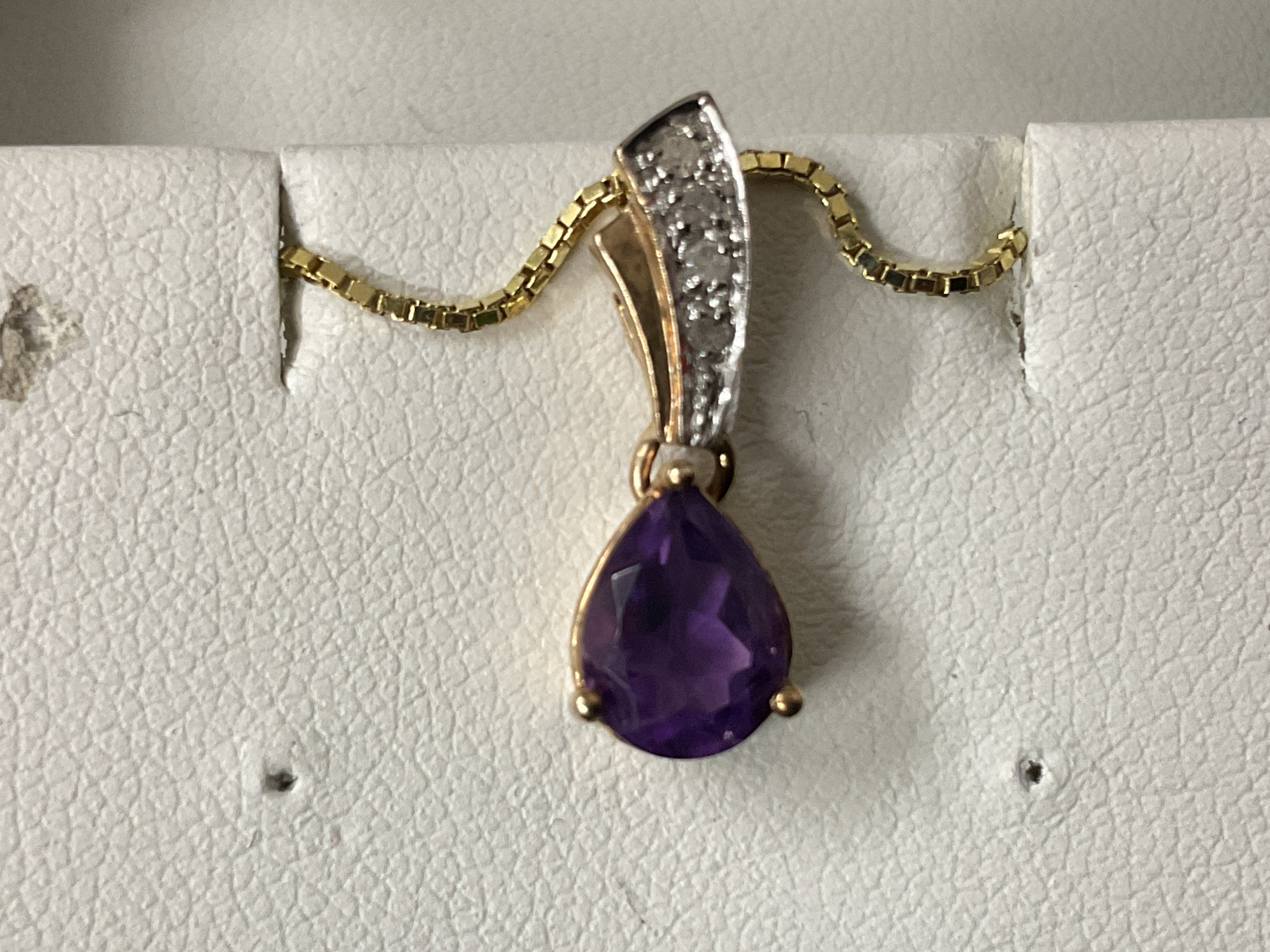 9ct yellow gold pear shaped amethyst pendant with a diamond set bale on a gold plated silver chain, boxed. Amethyst 1.00ct approx. Diamonds 0.05ct approx. Postage category A.