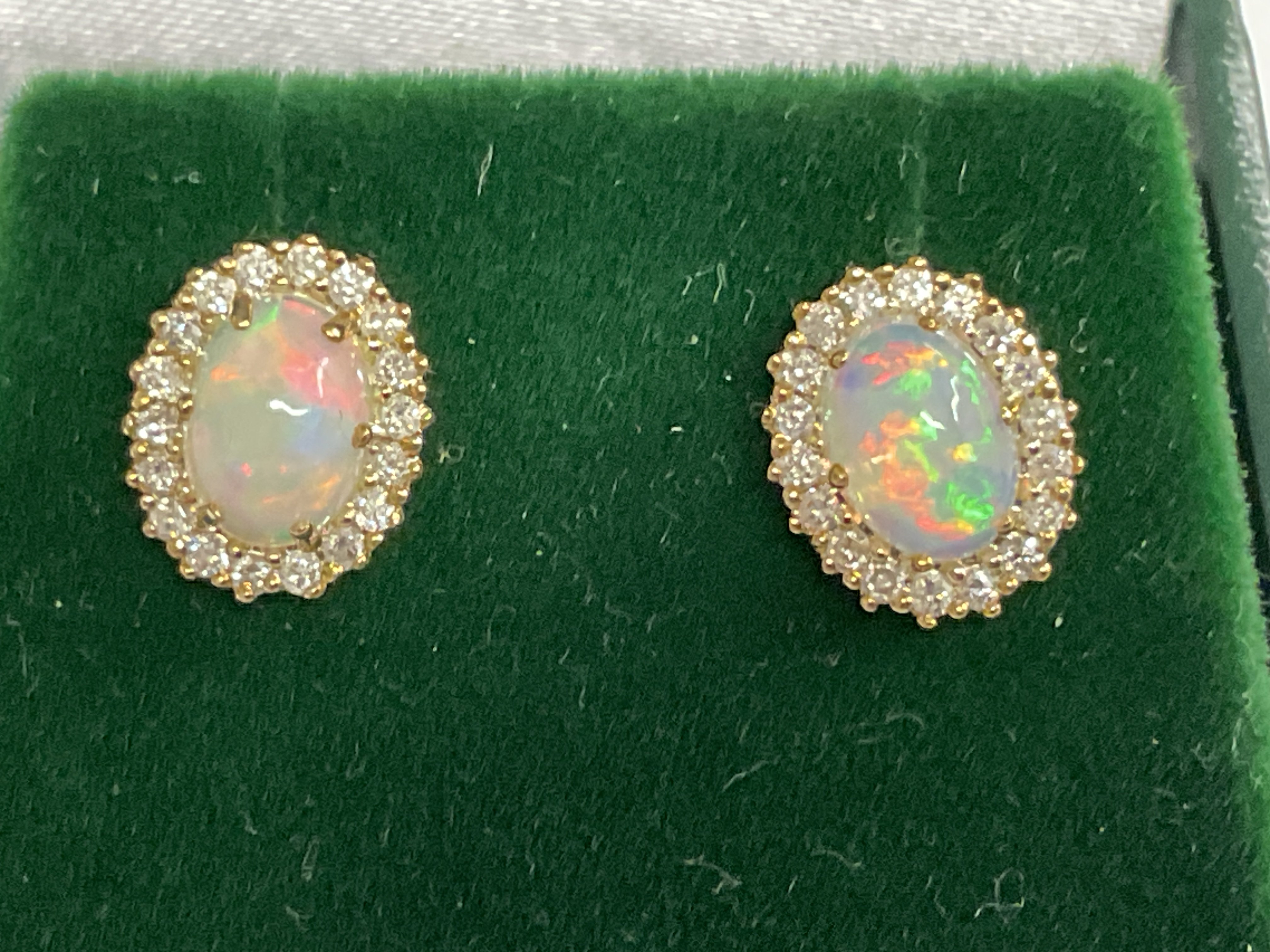 Pair of 9ct yellow gold oval cabochon Opal and RBC diamond cluster studs, boxed. Opals 1.08ct. Diamonds 0.29ct. Postage category A.
