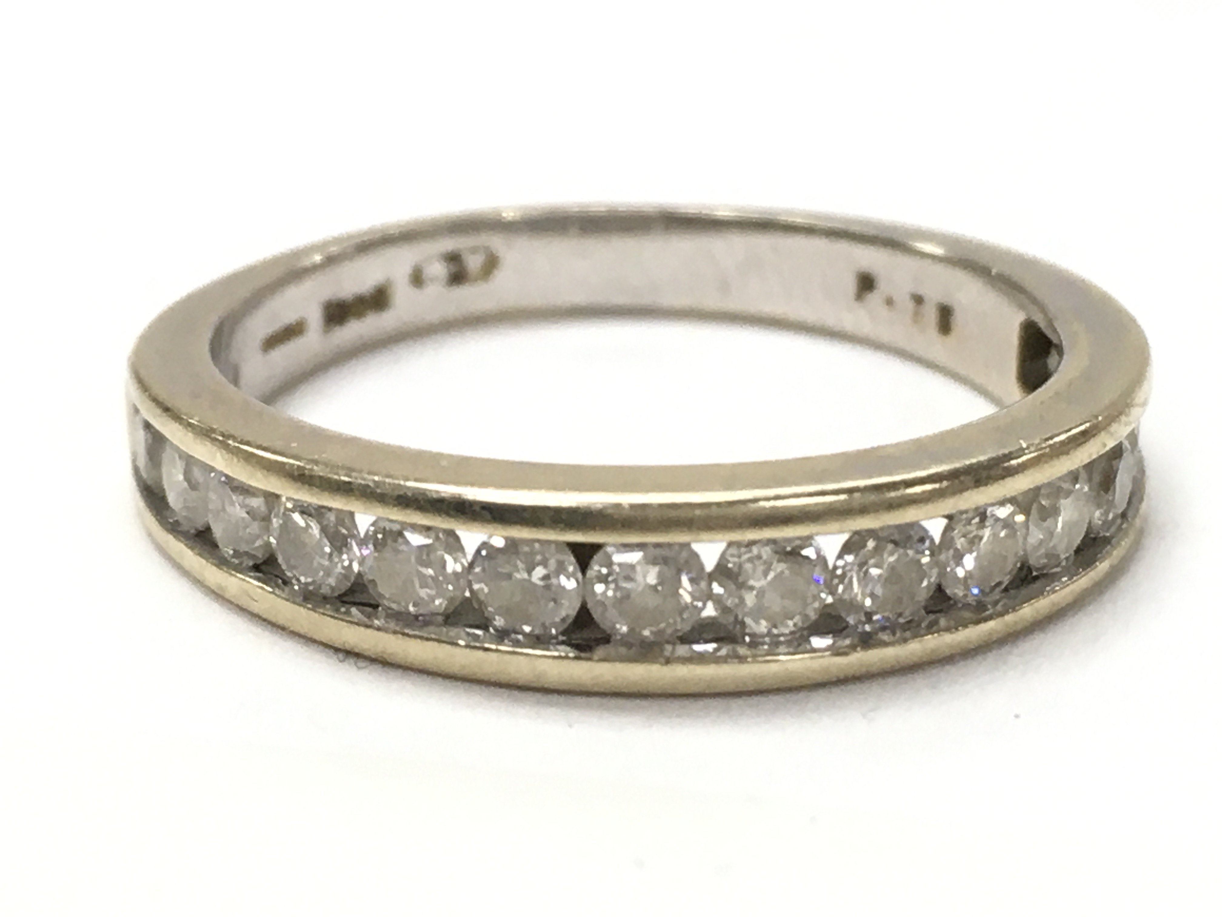 An 18ct half eternity ring, size O, total weight 3.7g. 0.75ct total diamond and Moissanite. Postage category A
