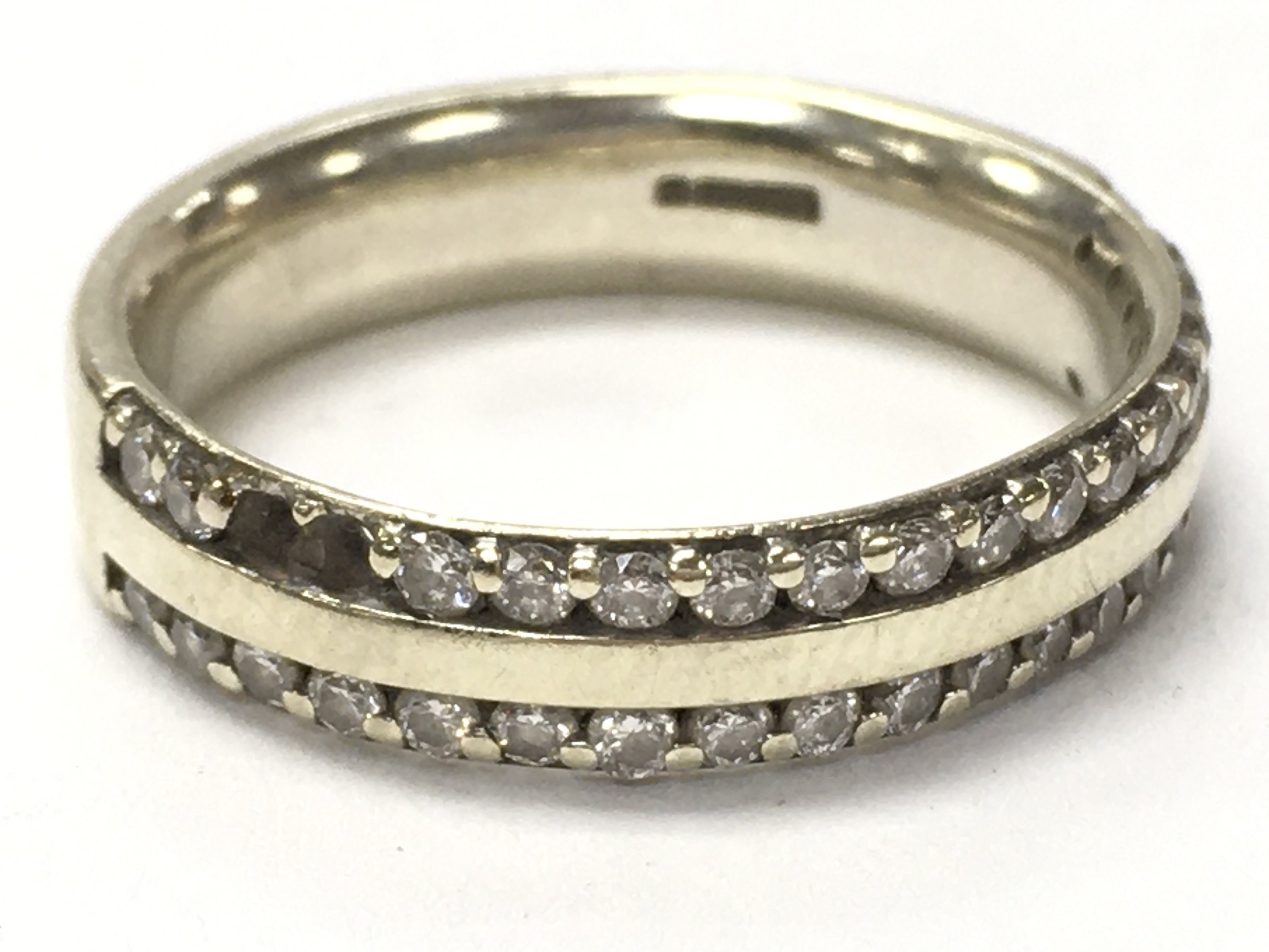 A 9ct gold double join half eternity ring , two stones missing. Size N. Total weight 4.65g. Postage category a