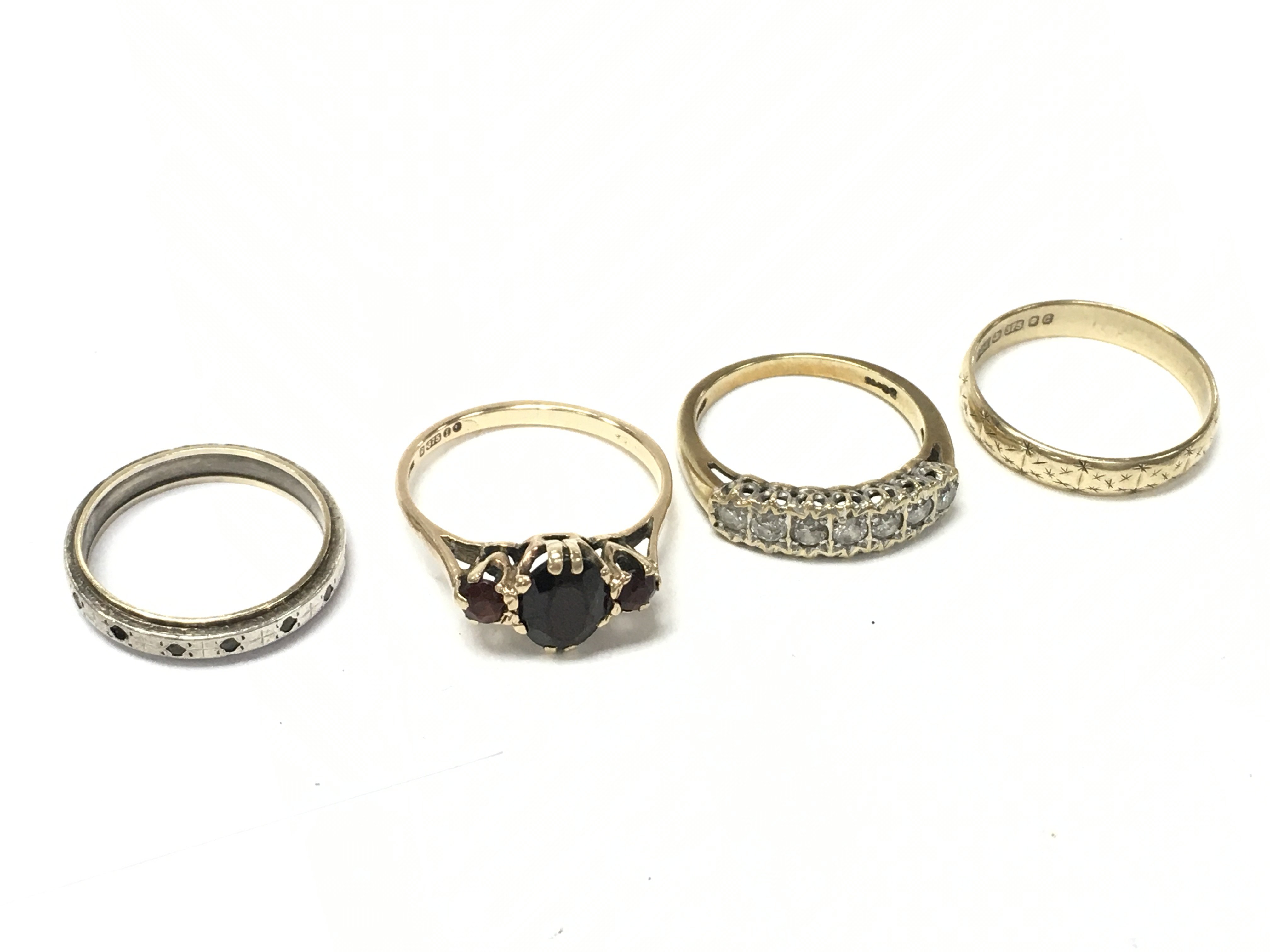 A Collection of 9ct gold rings including a Moissanite ring, ruby set ring, 9ct gold/silver ring. Total weight 9.5g. Postage category A