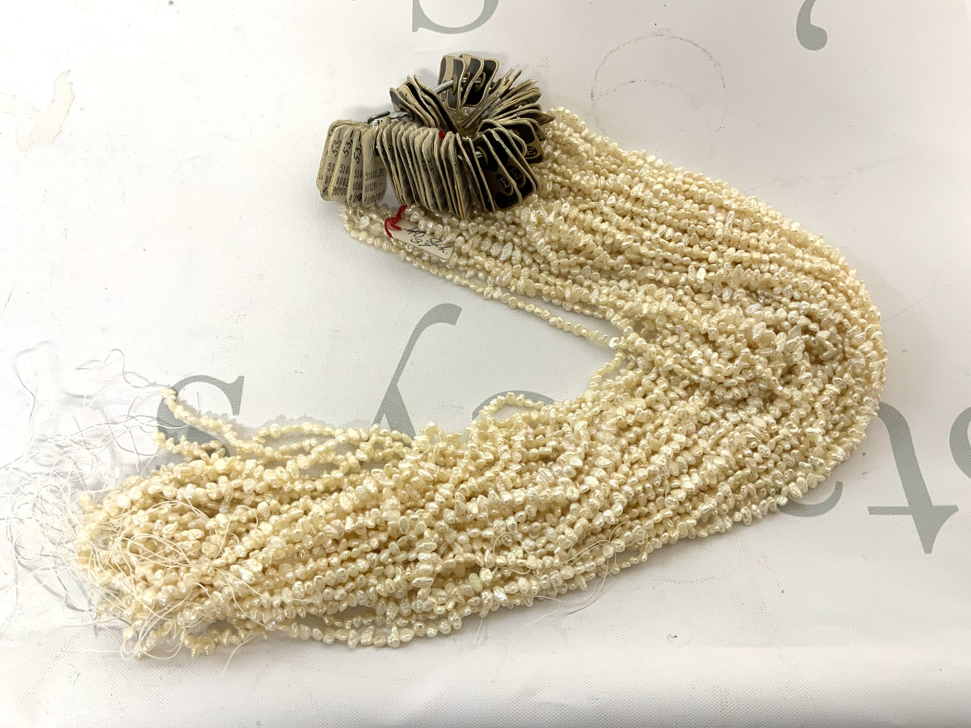 A large collection of seed pearl strands. (Approximately 39). A