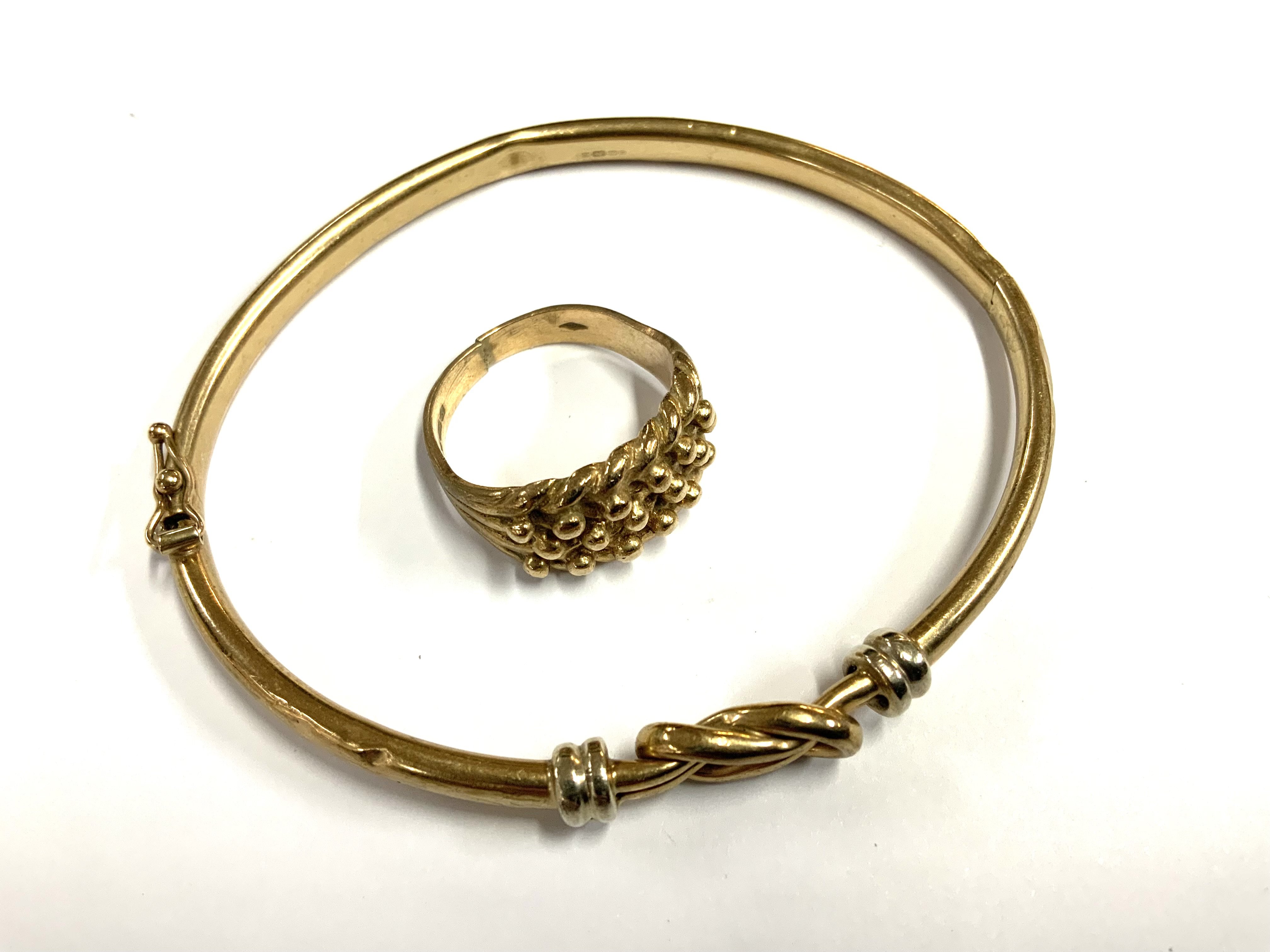 A 9ct gold bangle with woven knot design together with a 9ct gold keeper ring, Size O (total weight 12.99g)
