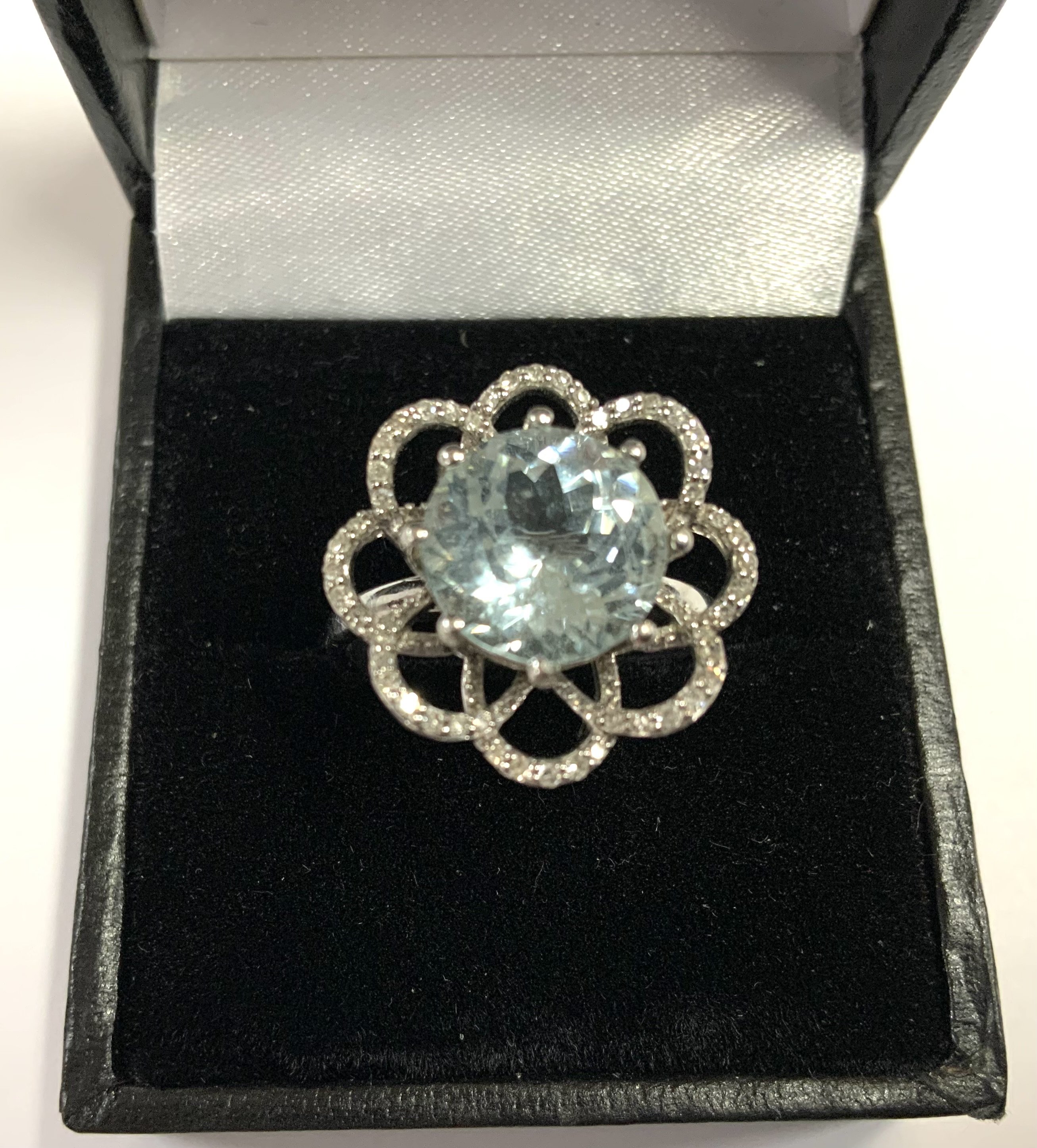 A white gold diamond and aquamarine ring in a floral design. 4.47g, Size P. (A)