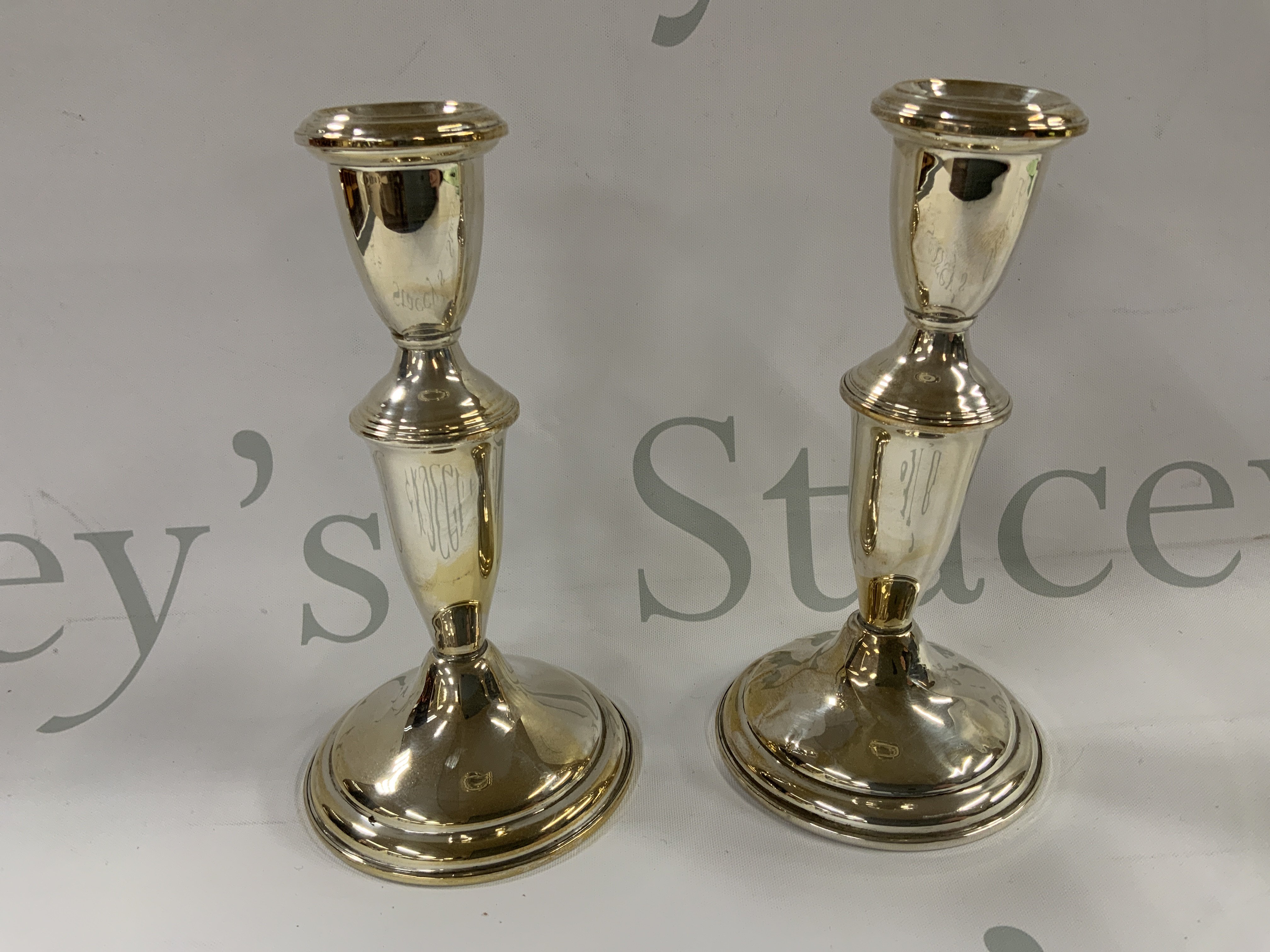 A pair of Sterling silver candlesticks. 15cm (A)
