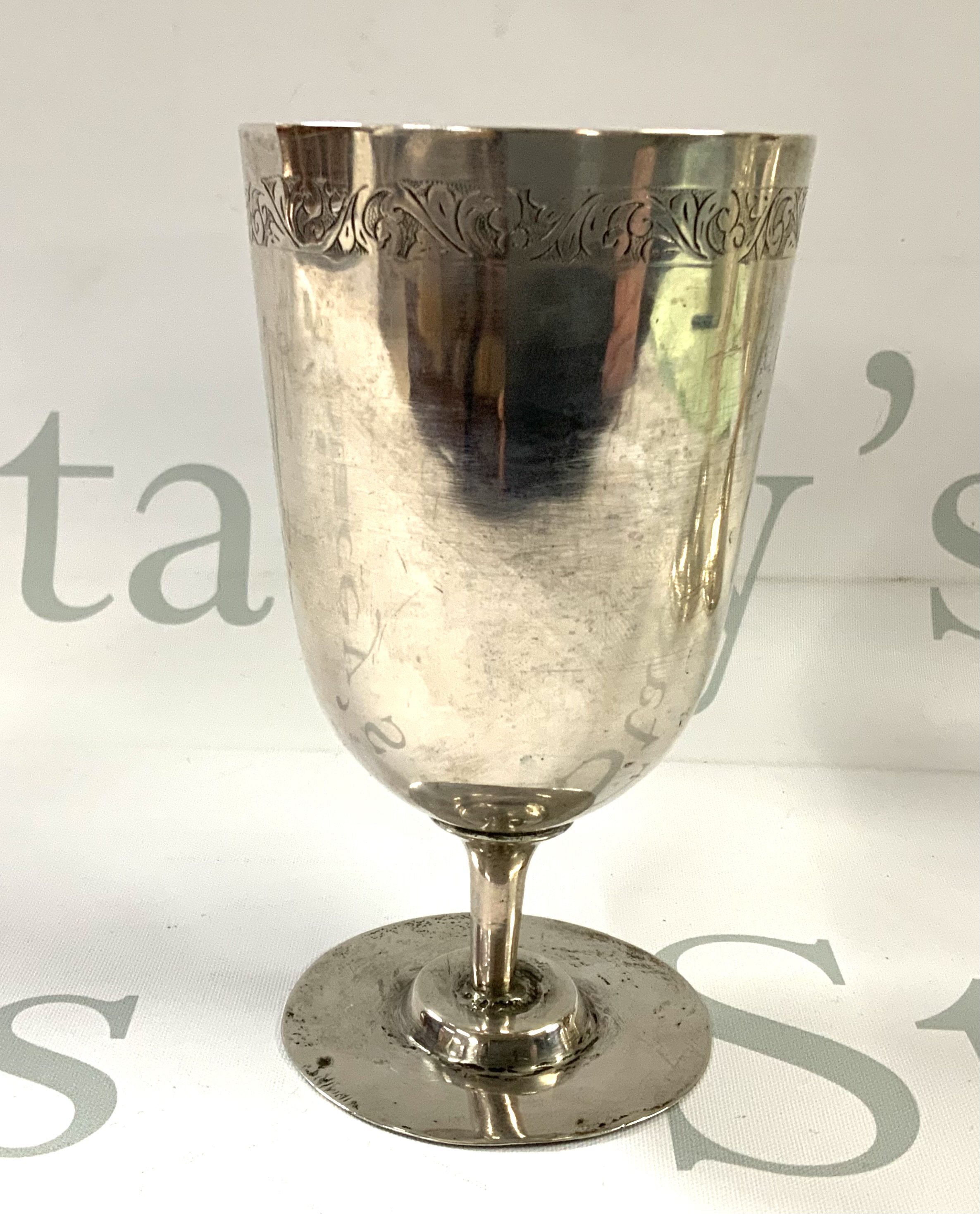 An unmarked early silver chalice (tested) with engraved border. 13cm. (Total weight 192g)