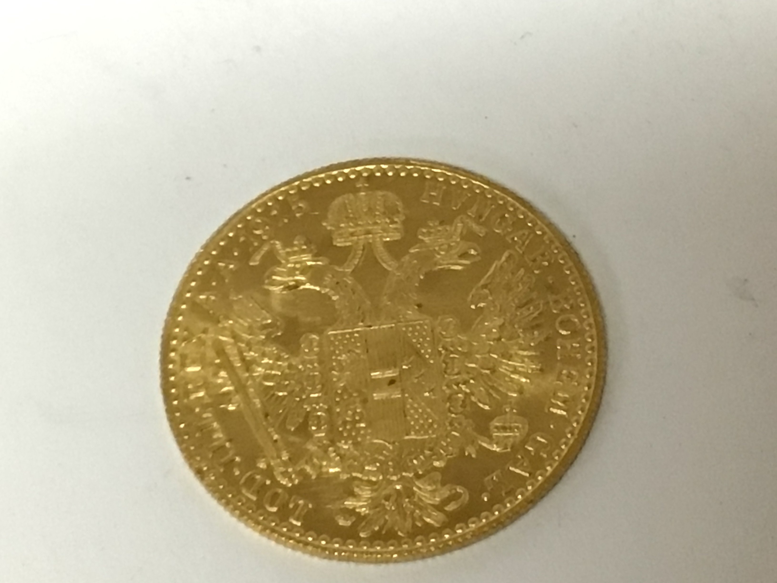 A gold Austrian coin dated 1915 depicting Francis Joseph I weight 3.5g