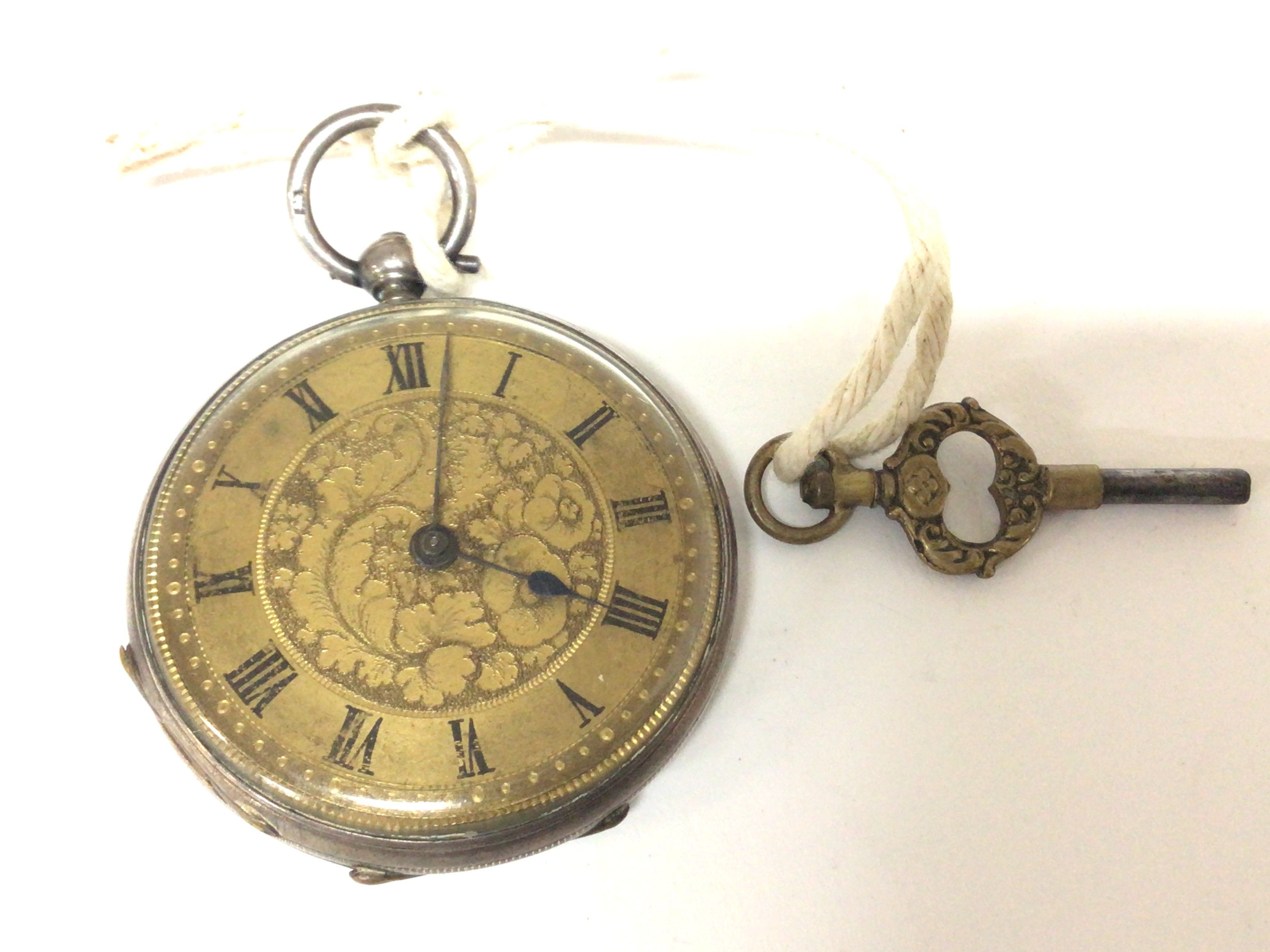 A silver cased key wind pocket watch with an elaborate dial. Seen working