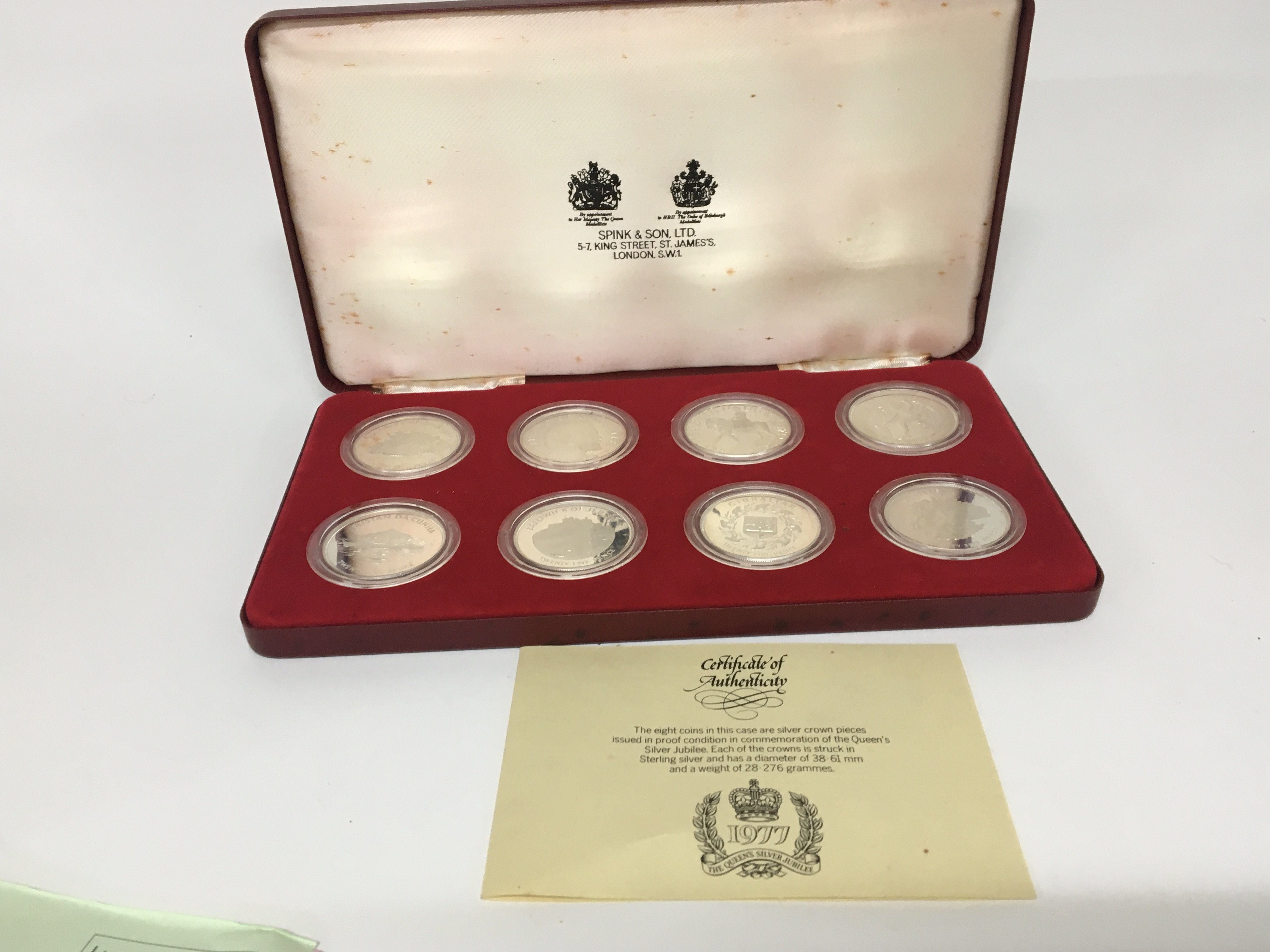 A cased set of eight silver 1977 commemorative coins in a fitted Spinks case with certificate of Authenticity. Each coin 28.2g (8)