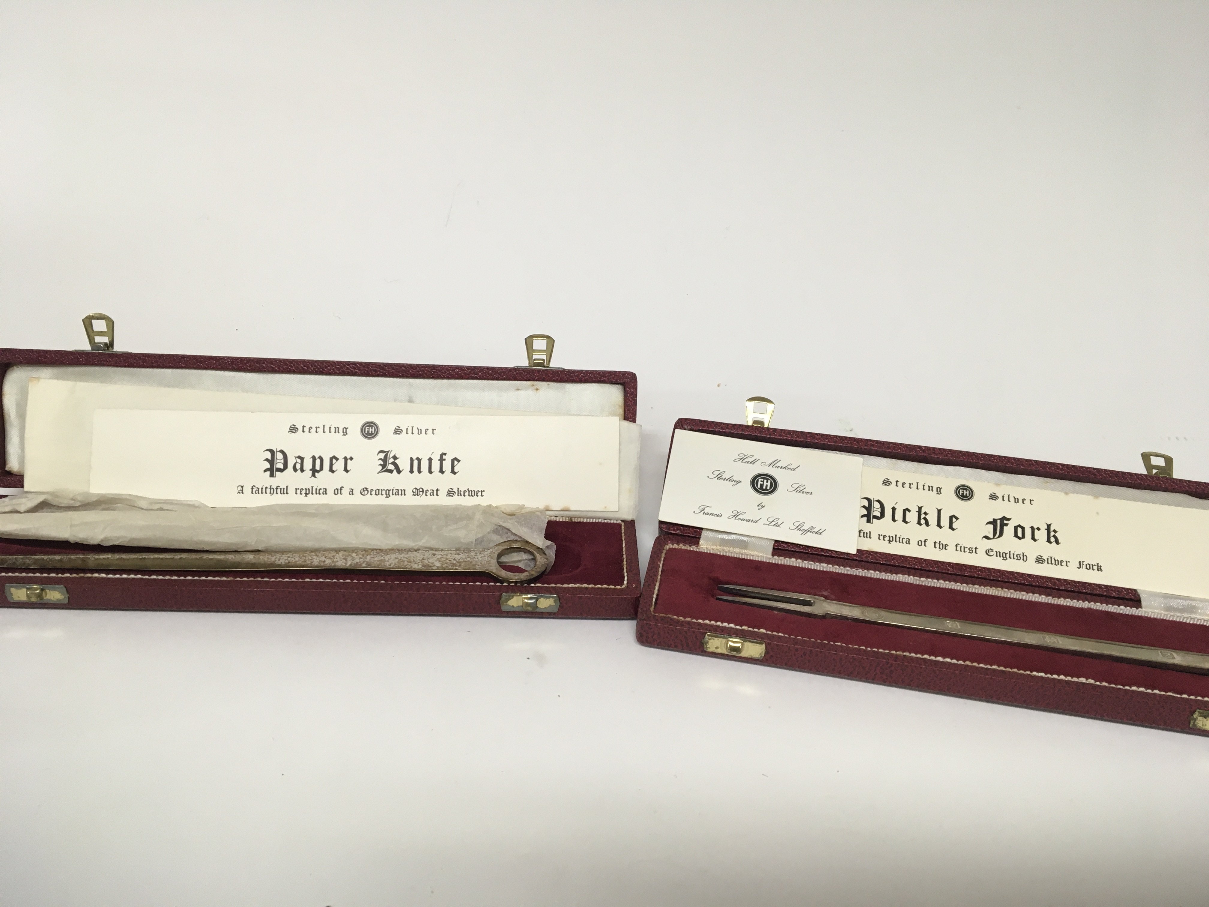 A silver paper knife and silver Pickle folk (2)