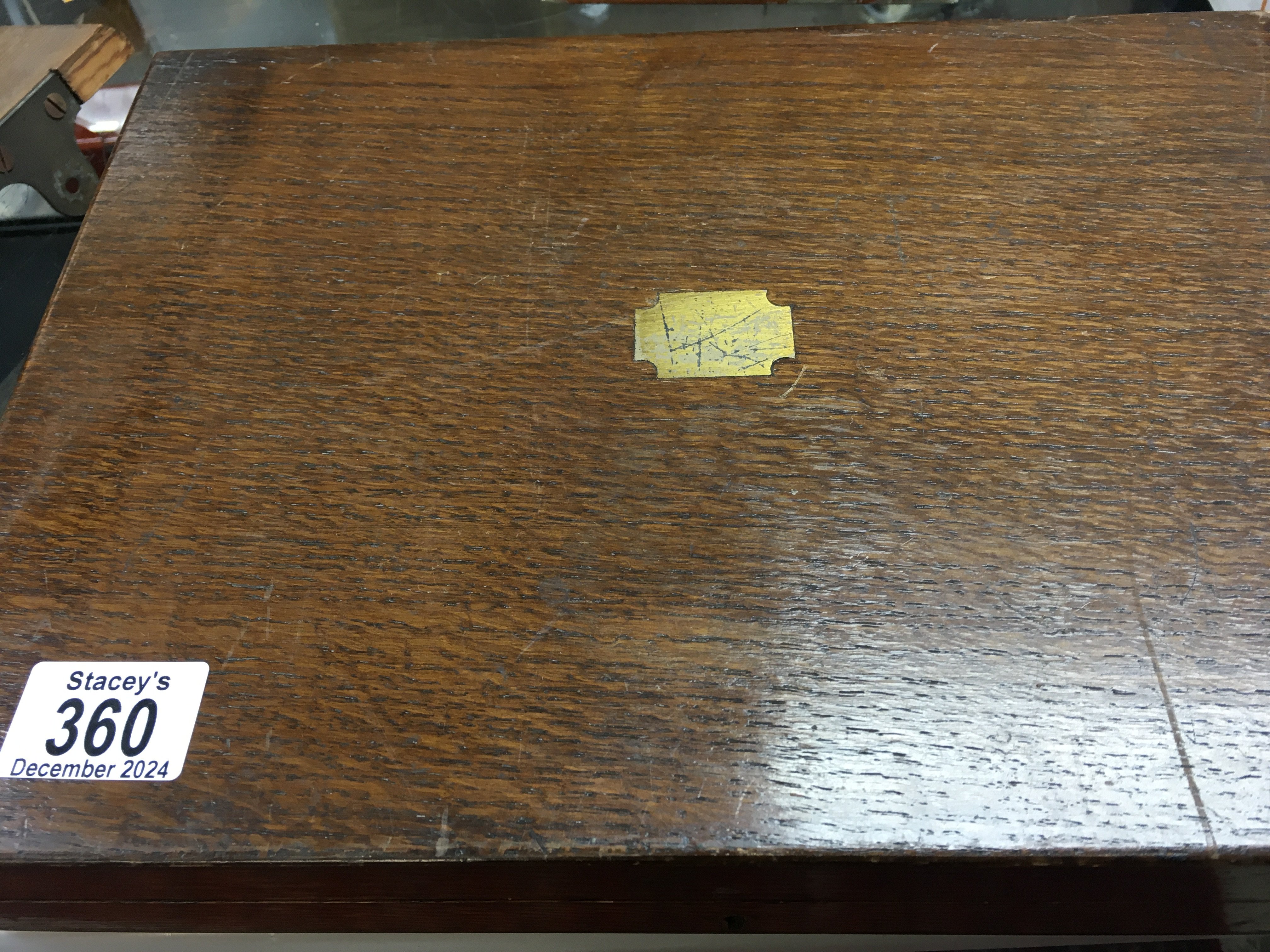 A oak case containing knifes and forks with silver handles.