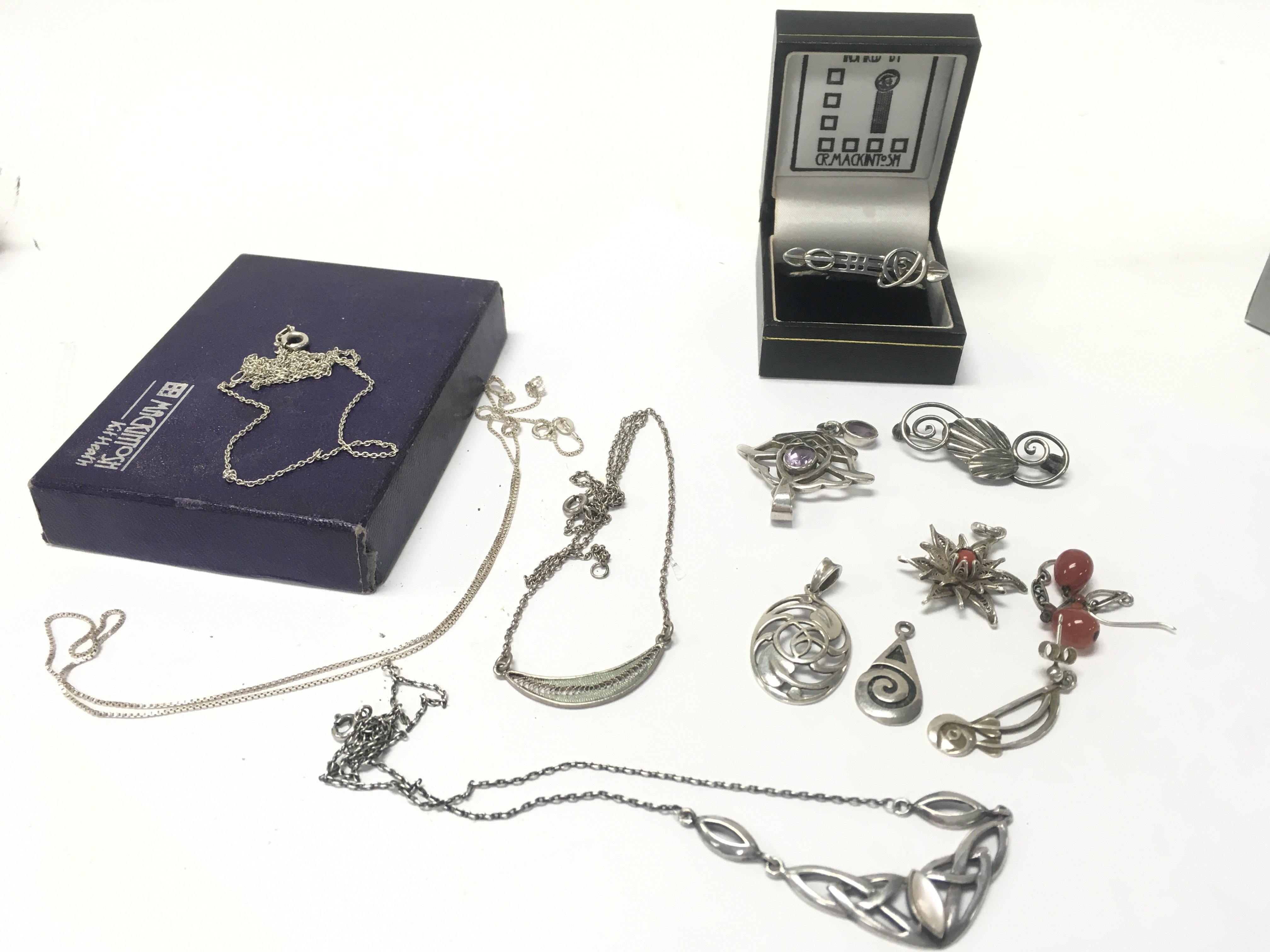 WITHDRAWN - A Collection of Mackintosh jewellery including some silver pieces and some silver chains. Postage category B
