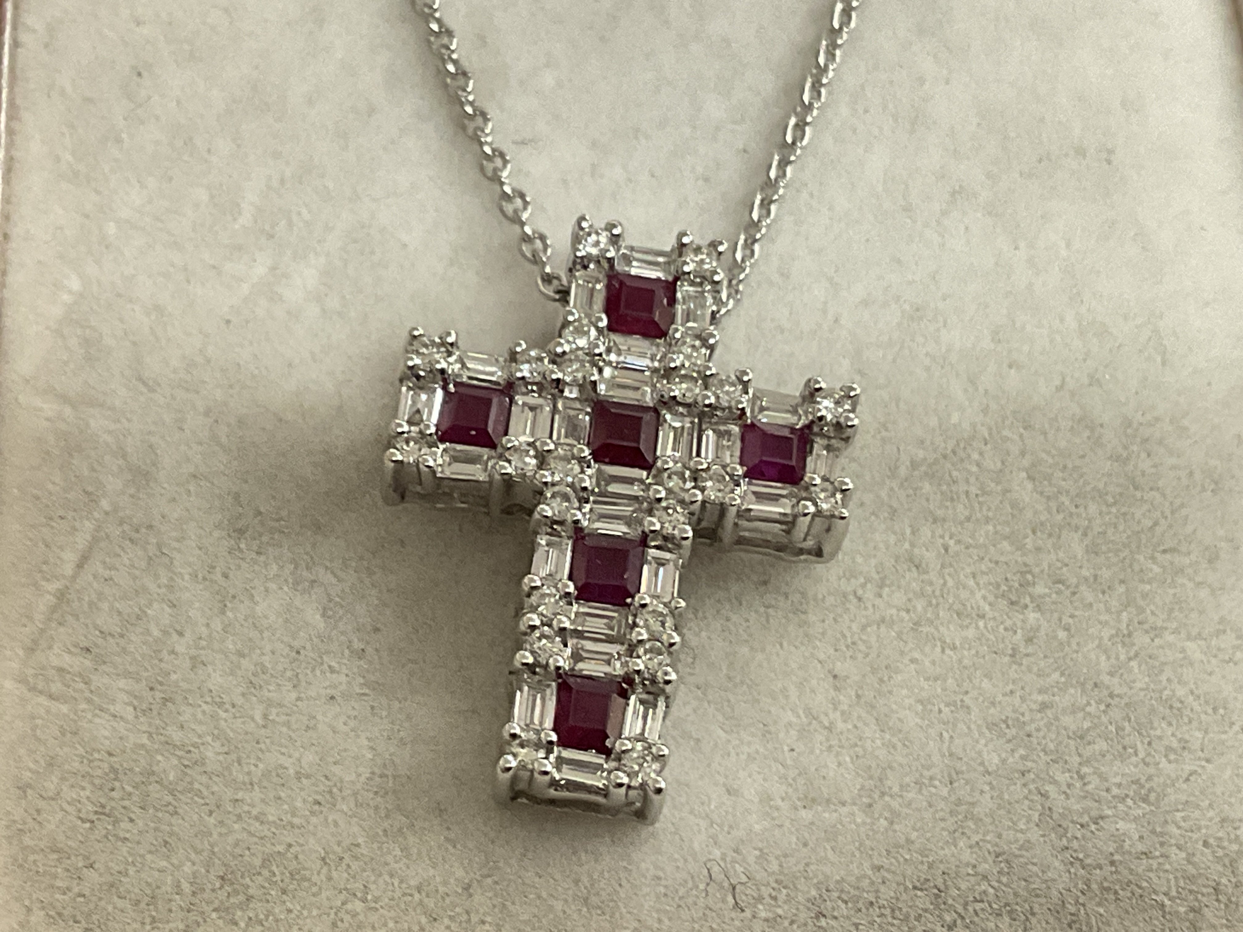 18ct diamond & ruby cross pendant. 18 platinum chain, 3.69g. 0.90ct rubies, 0.93ct diamonds. Postage category A.