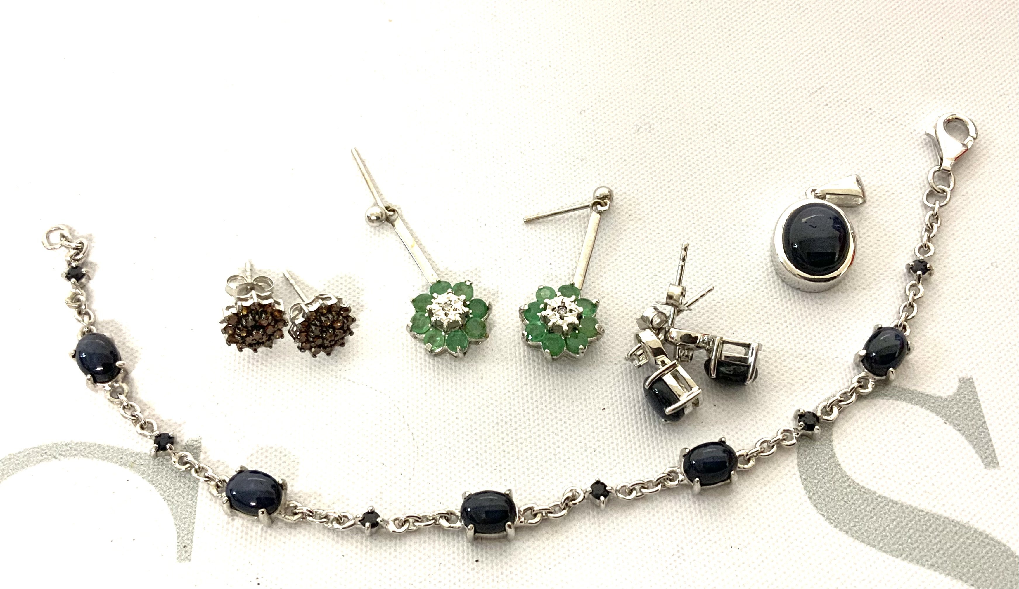 A small collection of silver and stone set jewellery to include a white gold emerald and diamond drop earrings. (A)