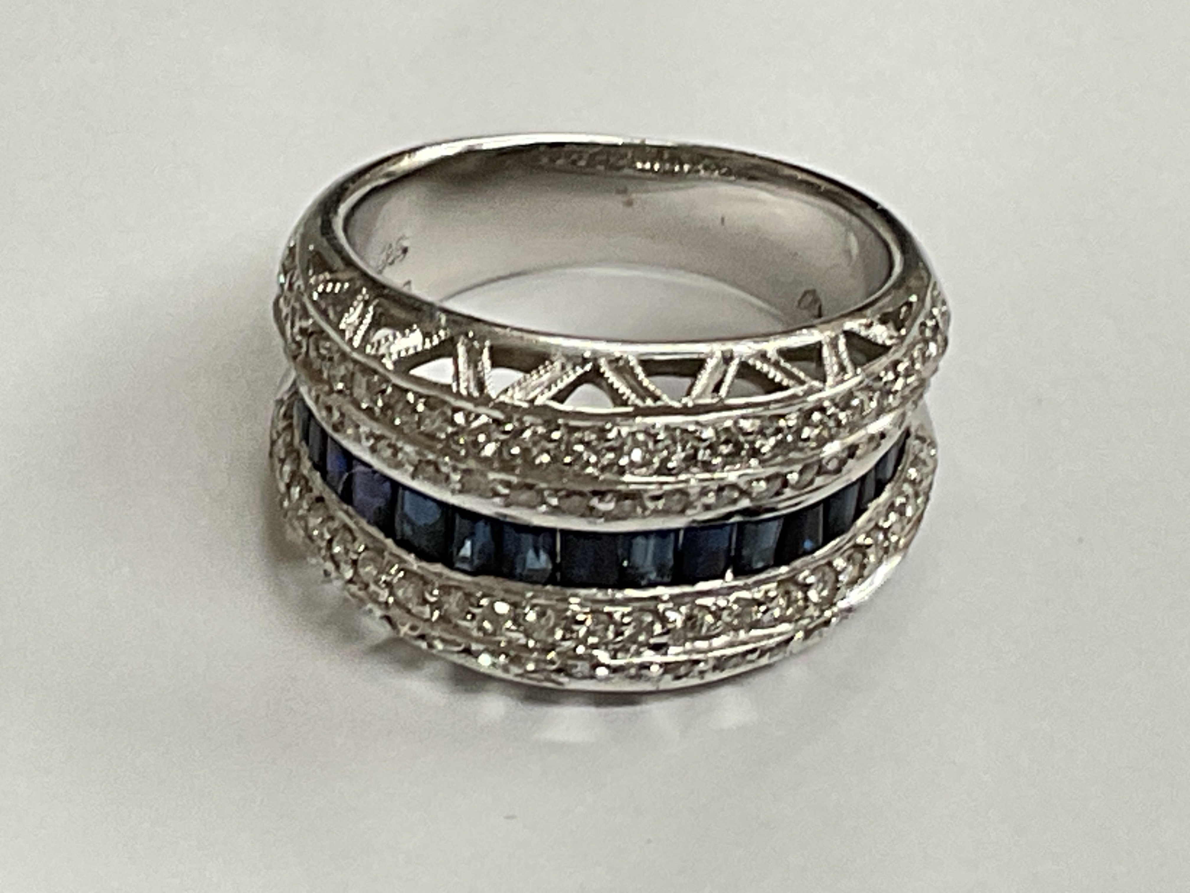 White gold sapphire and diamond ring. 0.75ct sapphires, 1.00ct diamonds, 8.8g. Ring size approx N. Postage category A.