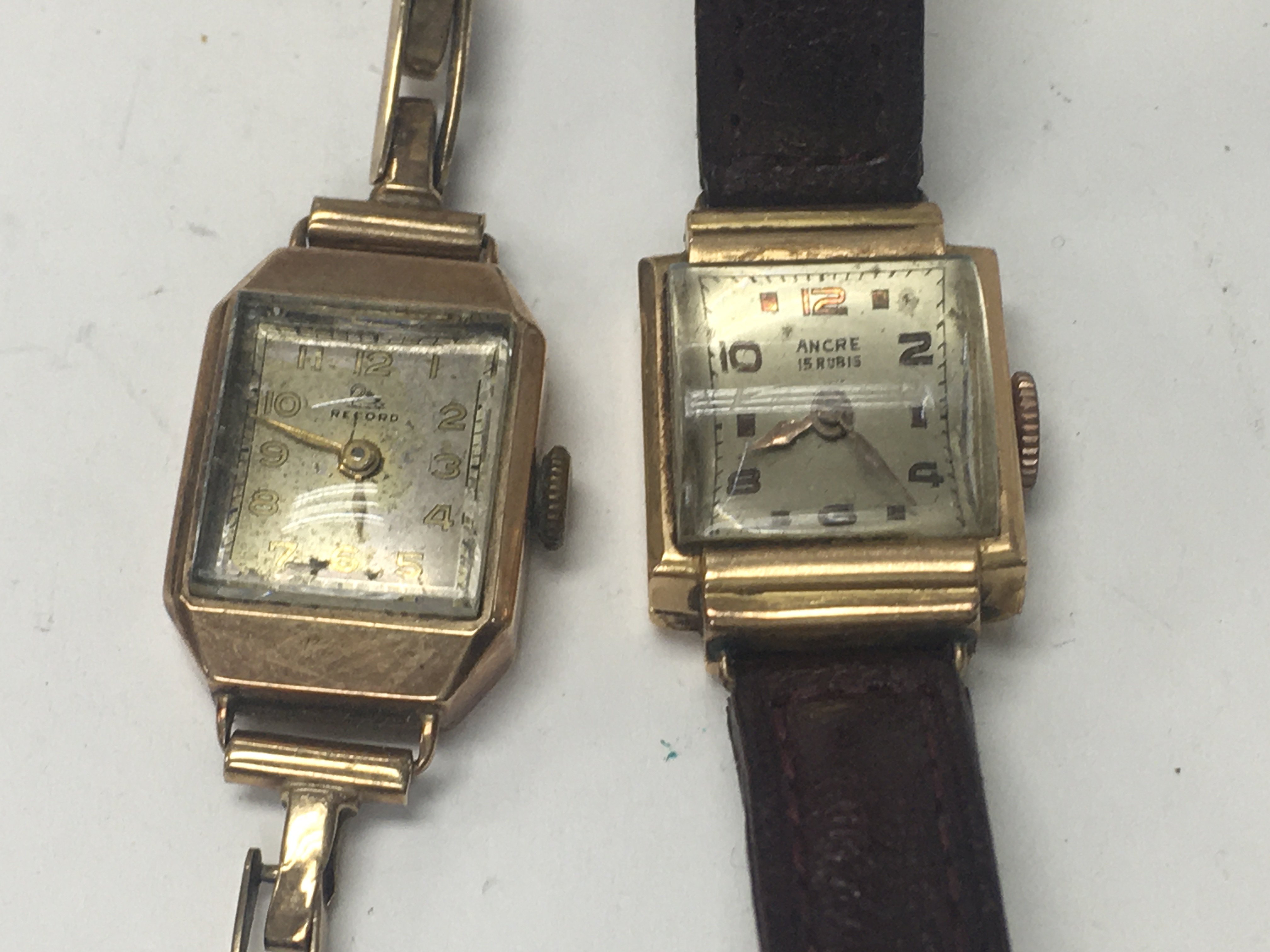 Two gold case wristwatches.