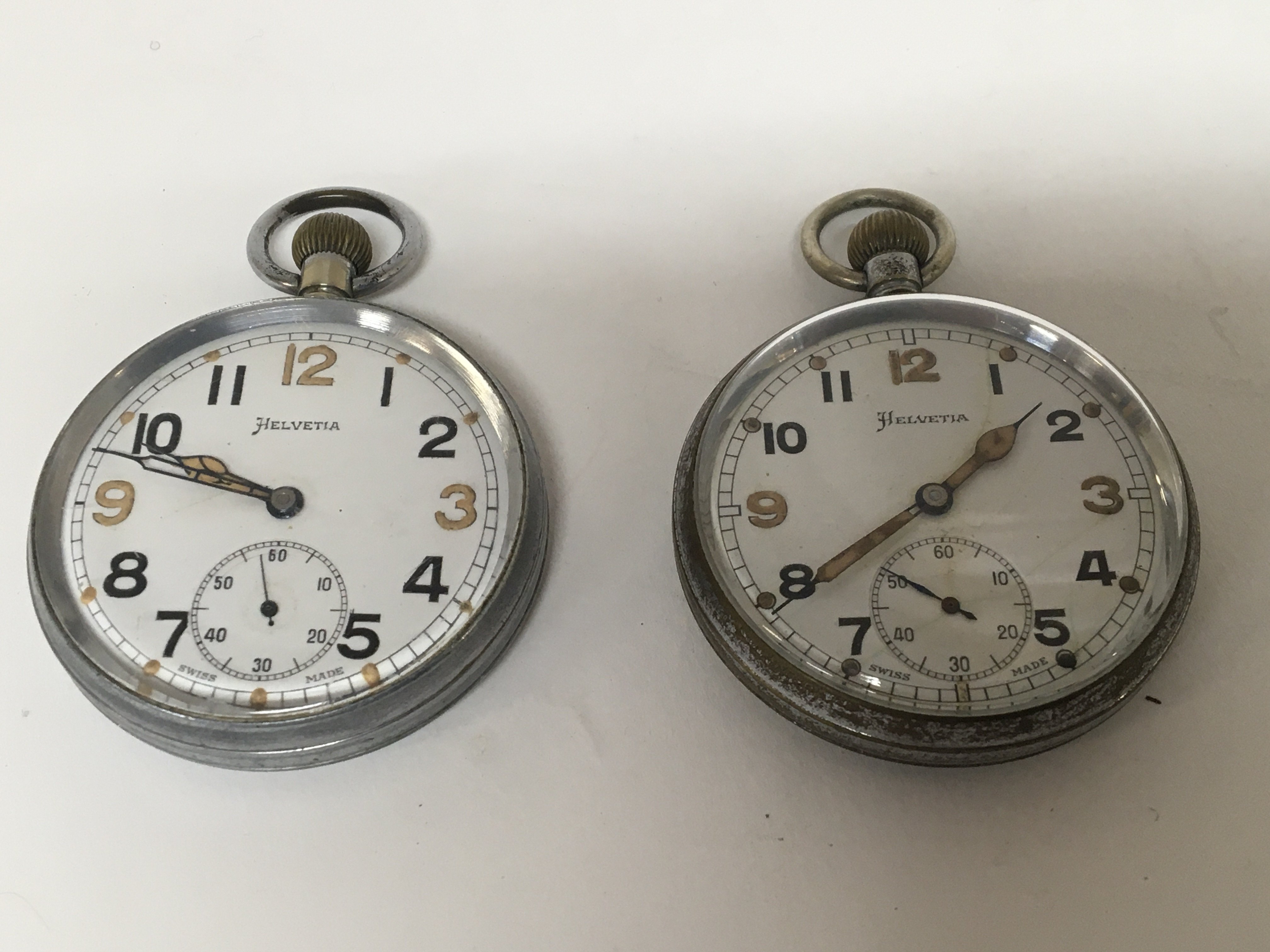 Two Military button wind pocket watches Swiss Made Helvetia both seen working. (2)