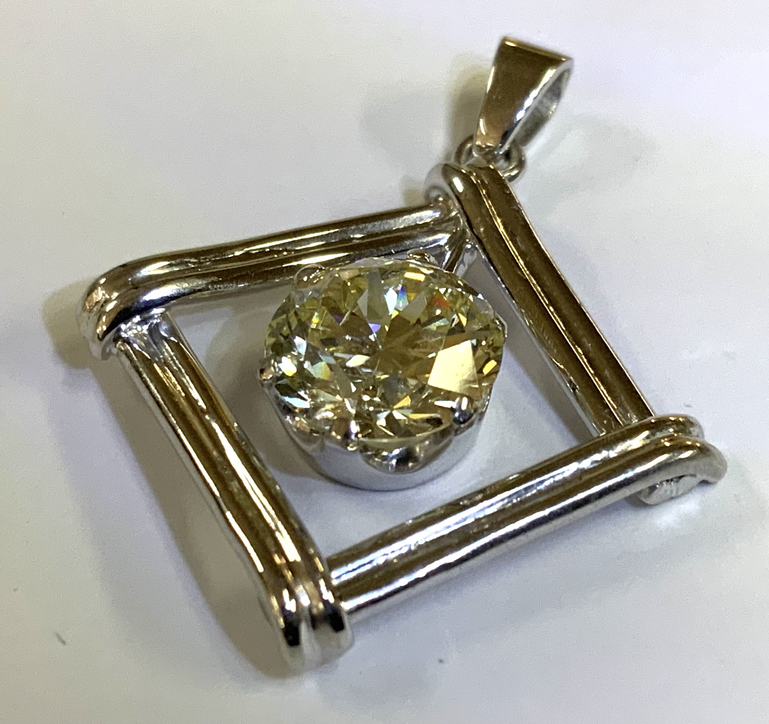 A single 2.05ct round brilliant cut diamond, Colour O/P, Clarity VS2 ( stone measurements 8.17-8.30 x 4.85mm. Mounted in an 6 claw 9ct white gold pendant mount with a 14ct gold rope necklace. (A)