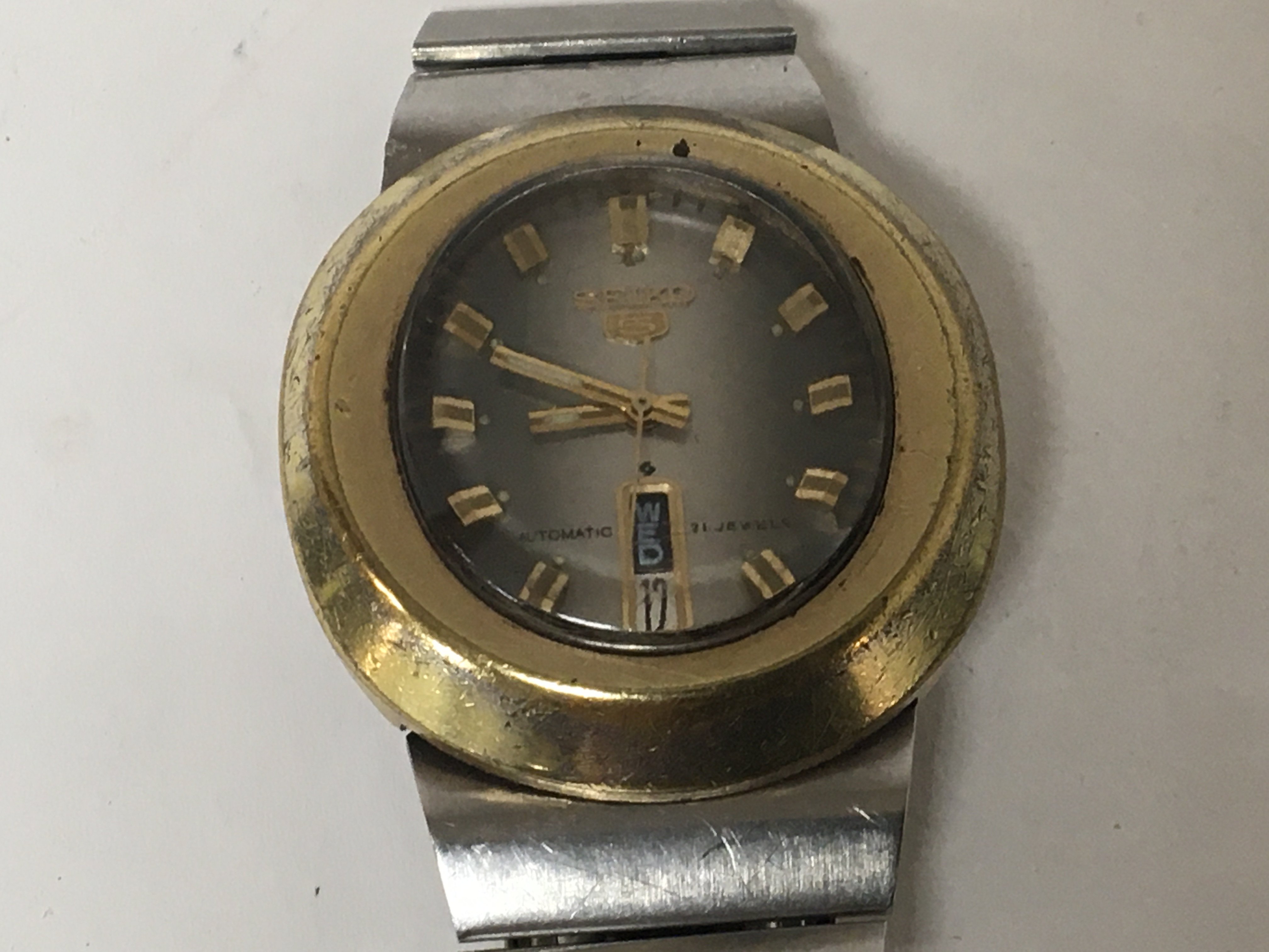 A rare Gents Vintage Seiko 5 wrist watch Automatic 21 Jewel with an oval brass vase and vertical day date serial number 441088 not seen working.