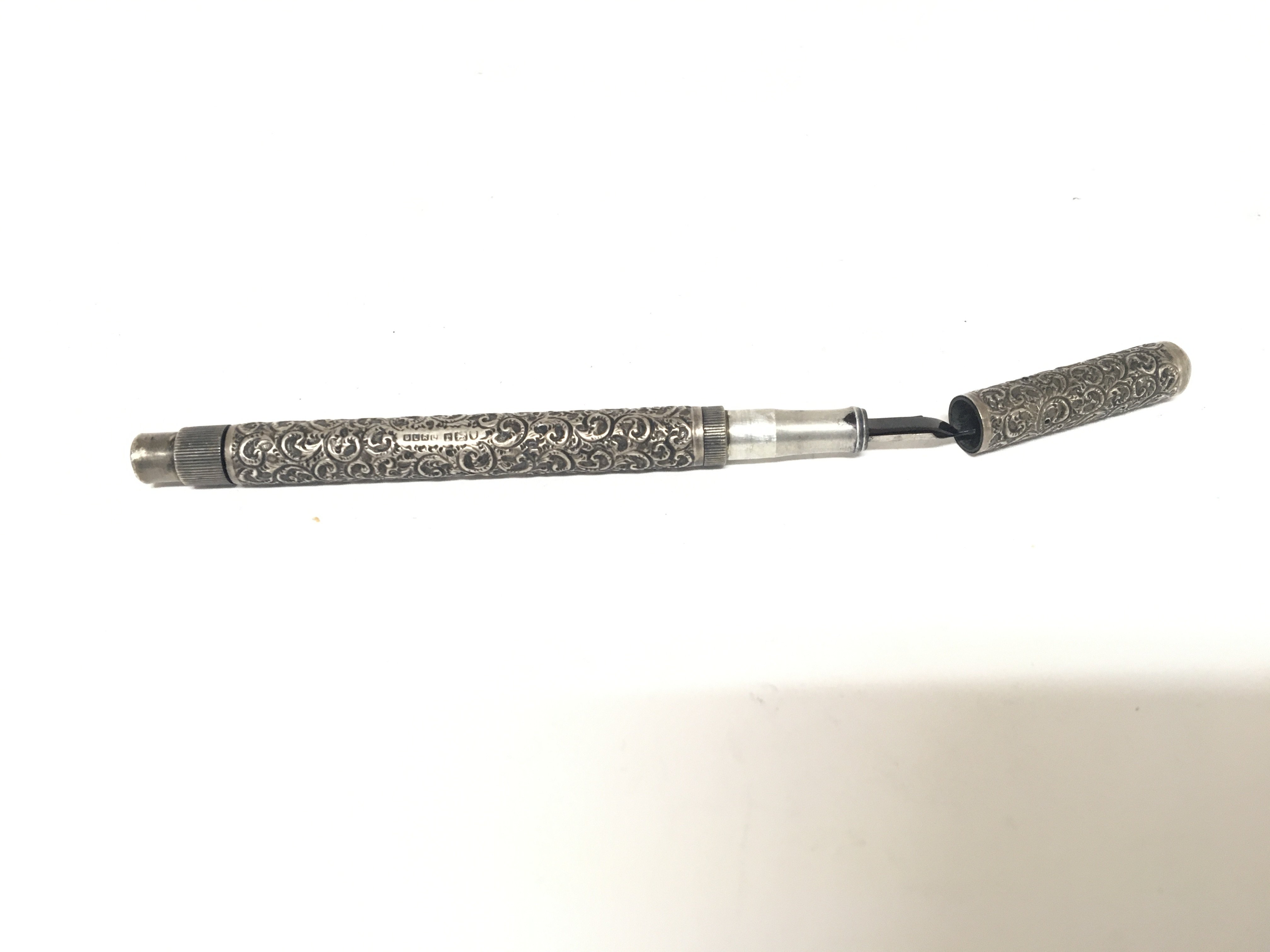 An early example of a silver cased fountain ink plunger pen onoto delerue with an outer silver case London 1912 hallmarks maker D L R Ltd.