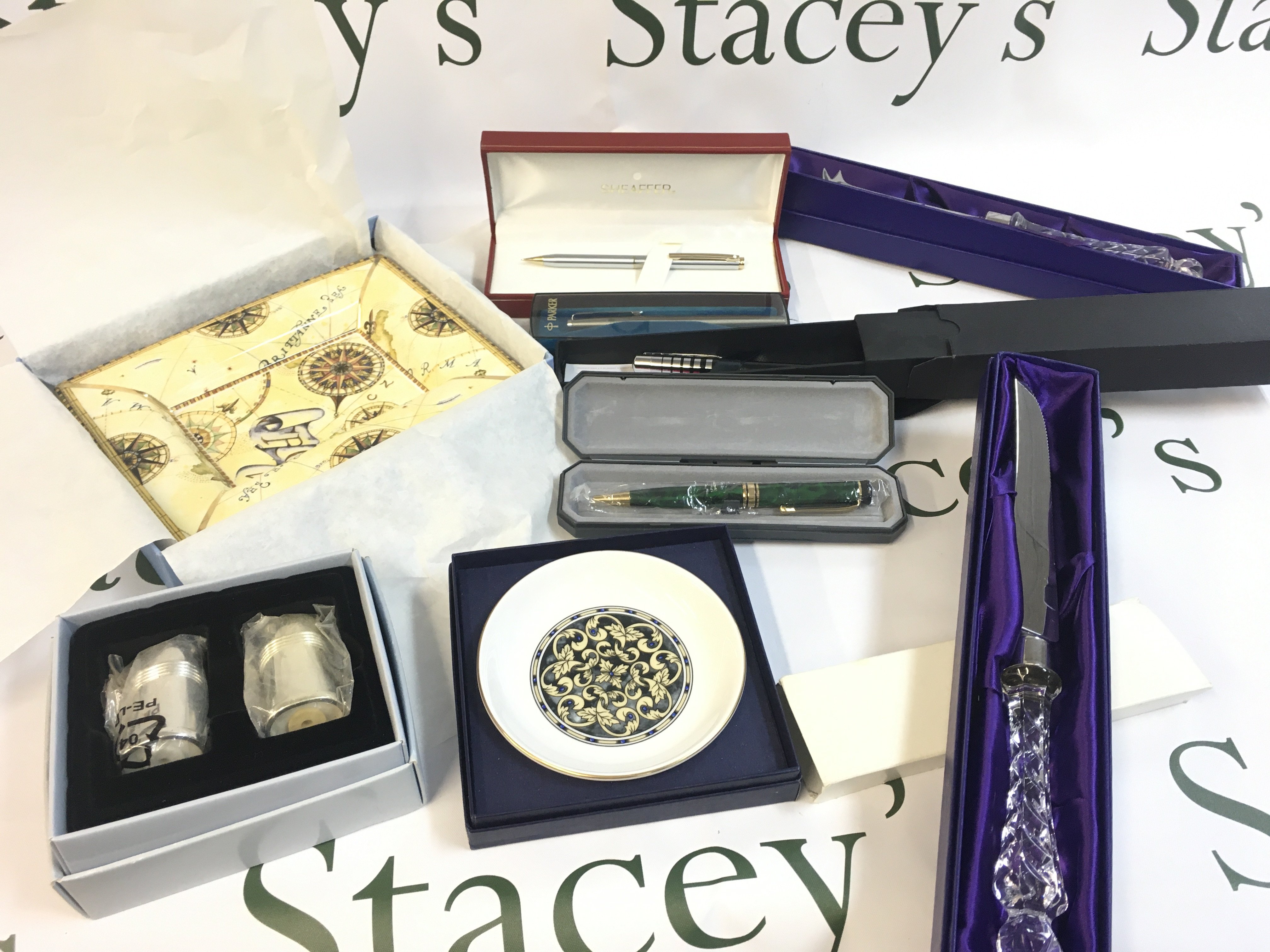 A Collection of pens including Parker, Sheaffer and boxed Edinburgh crystal cake knives, boxed porcelain Wedgwood Atlas dish. This lot cannot be posted