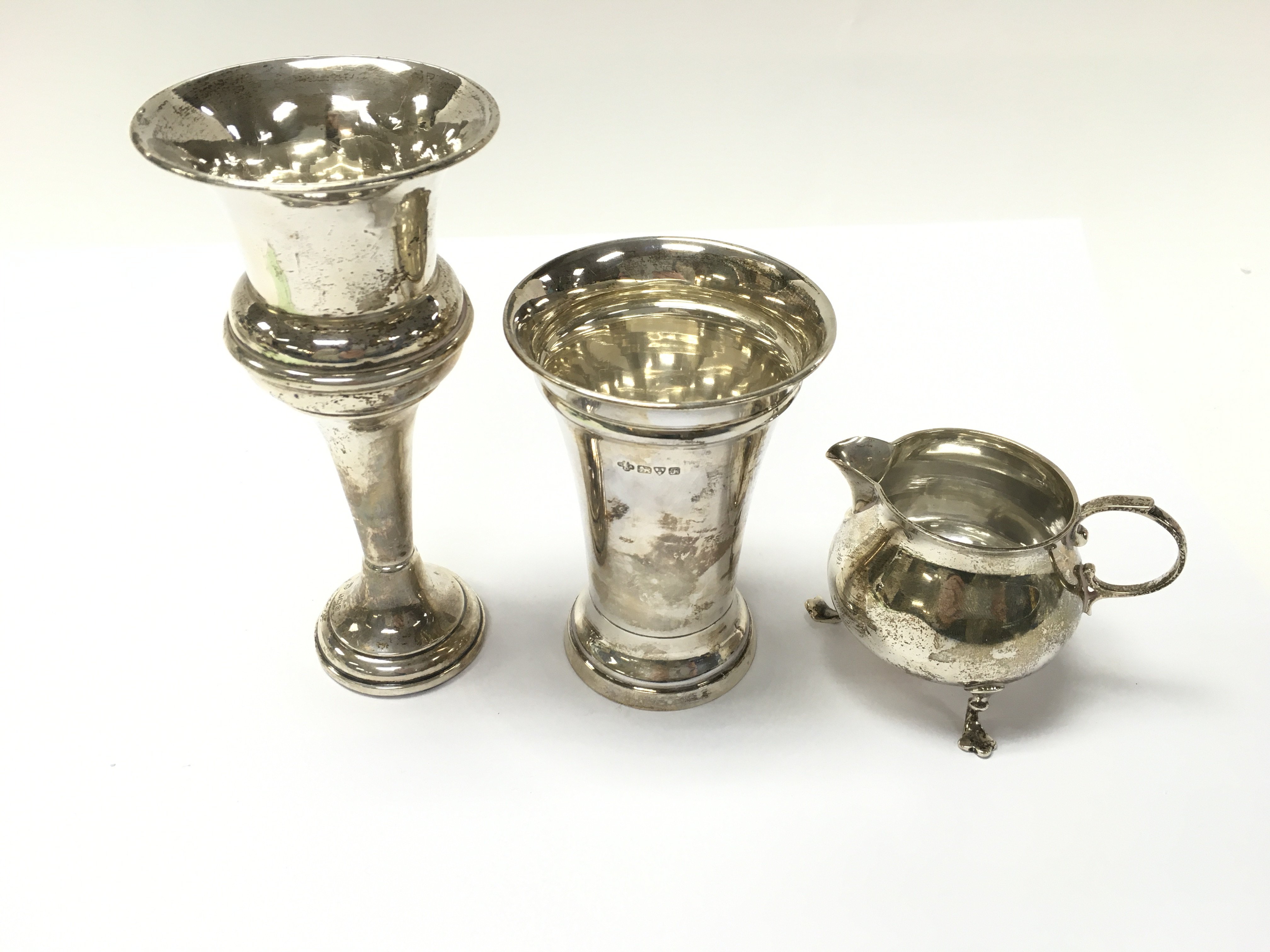 A collection of three items of silver including jug and vases. Total weight 276g. Postage B