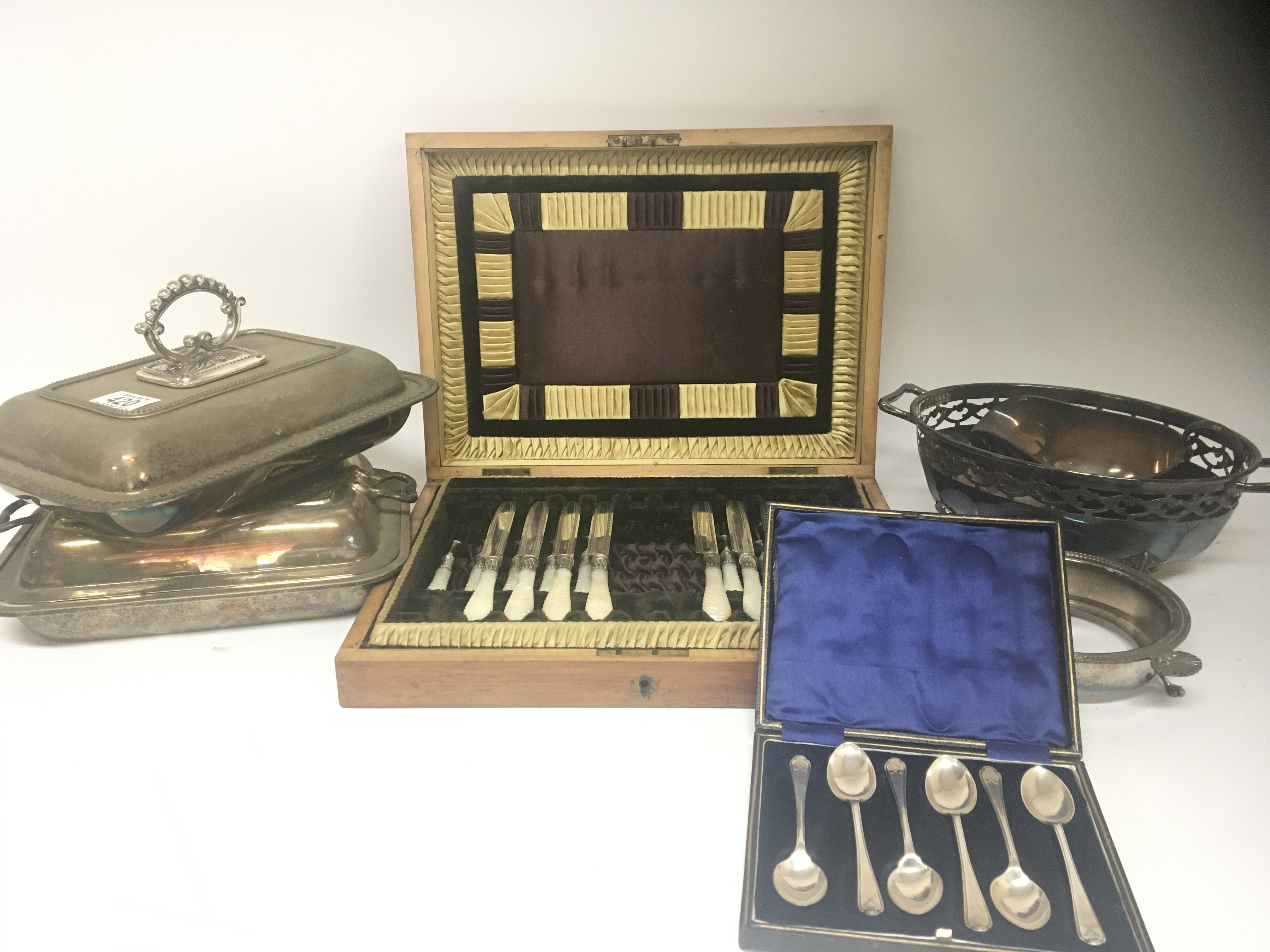 A cased set of silver spoons Sheffield hallmarks a part set of silver plated fruit knifes with mother of pearl handles and other silver plate.