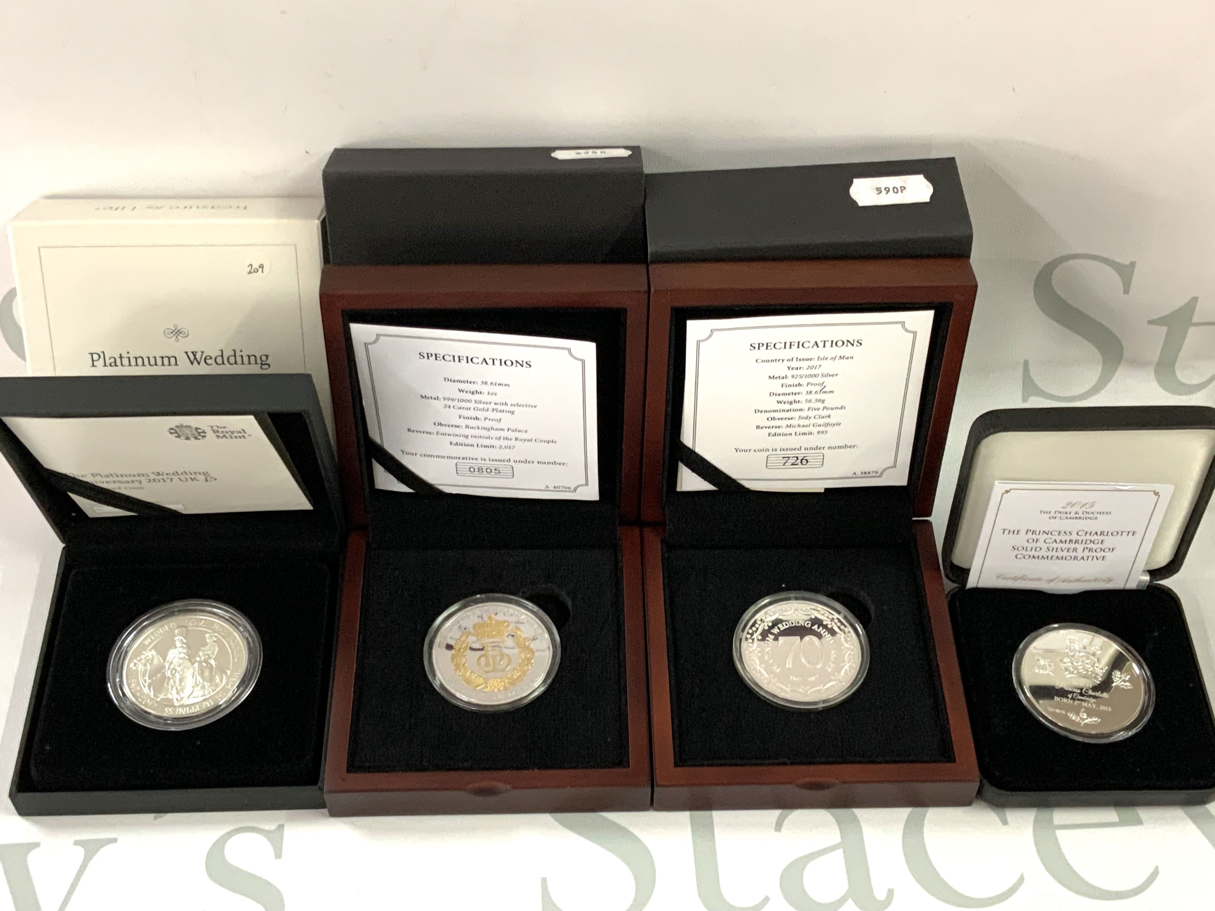 A cased Royal Mint Platinum Wedding anniversary &pound;5 silver coin together with 3 commemorative silver cased coins. (A)