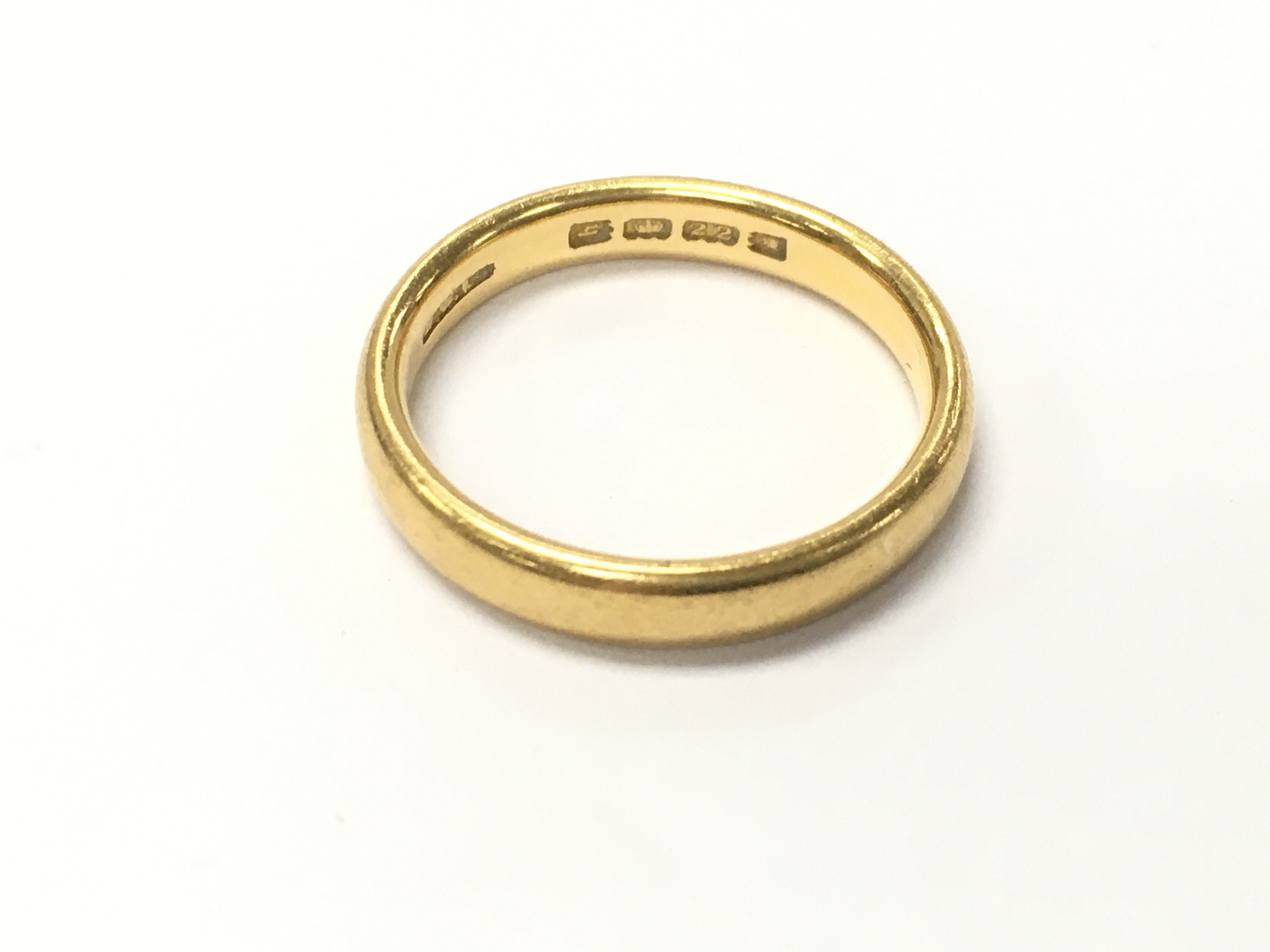 A 22ct gold band. 5.15g size N Postage A