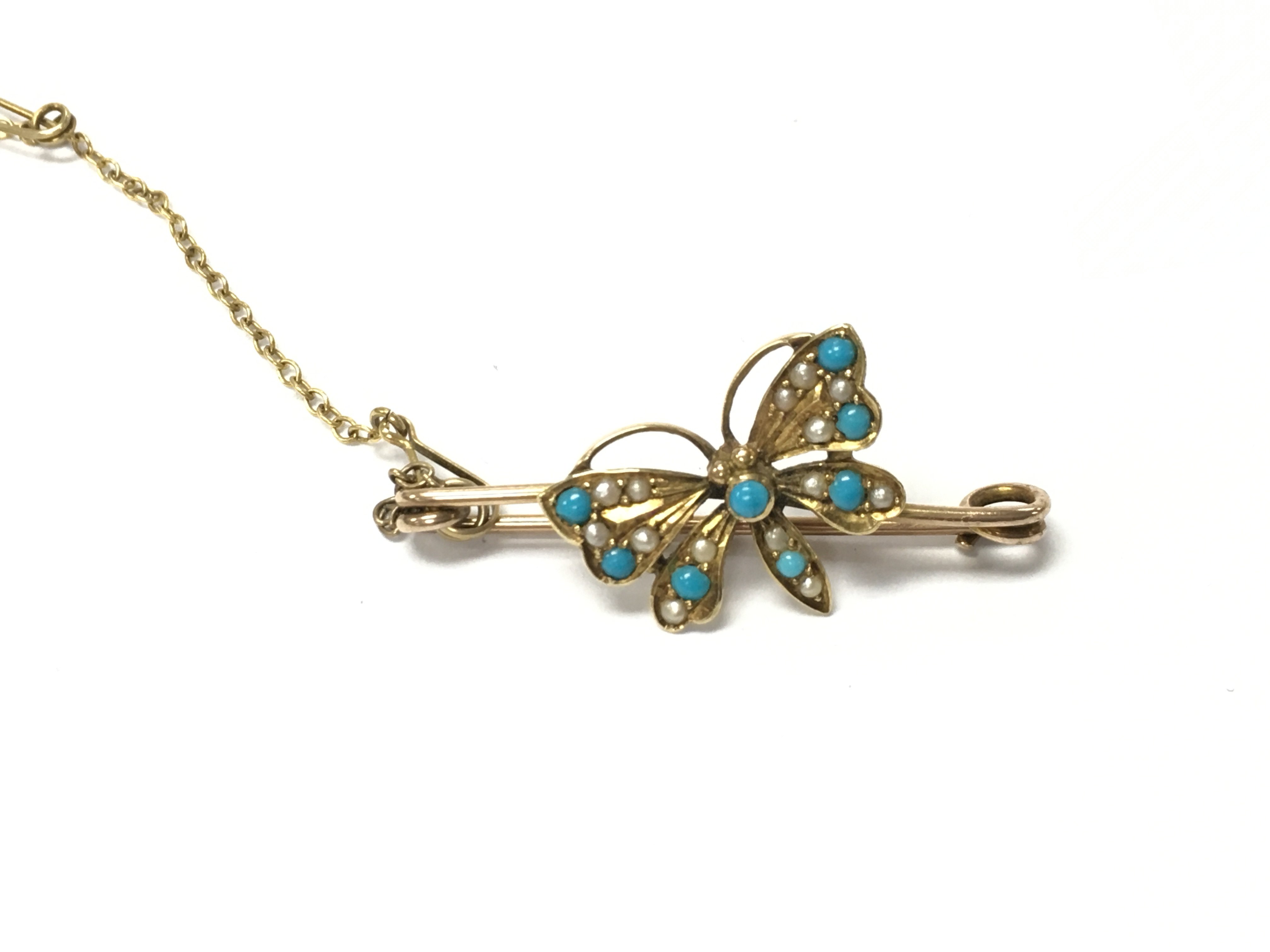 A gold brooch in the form of a butterfly set with turquoise. Approximately 40mm and 2.79g
