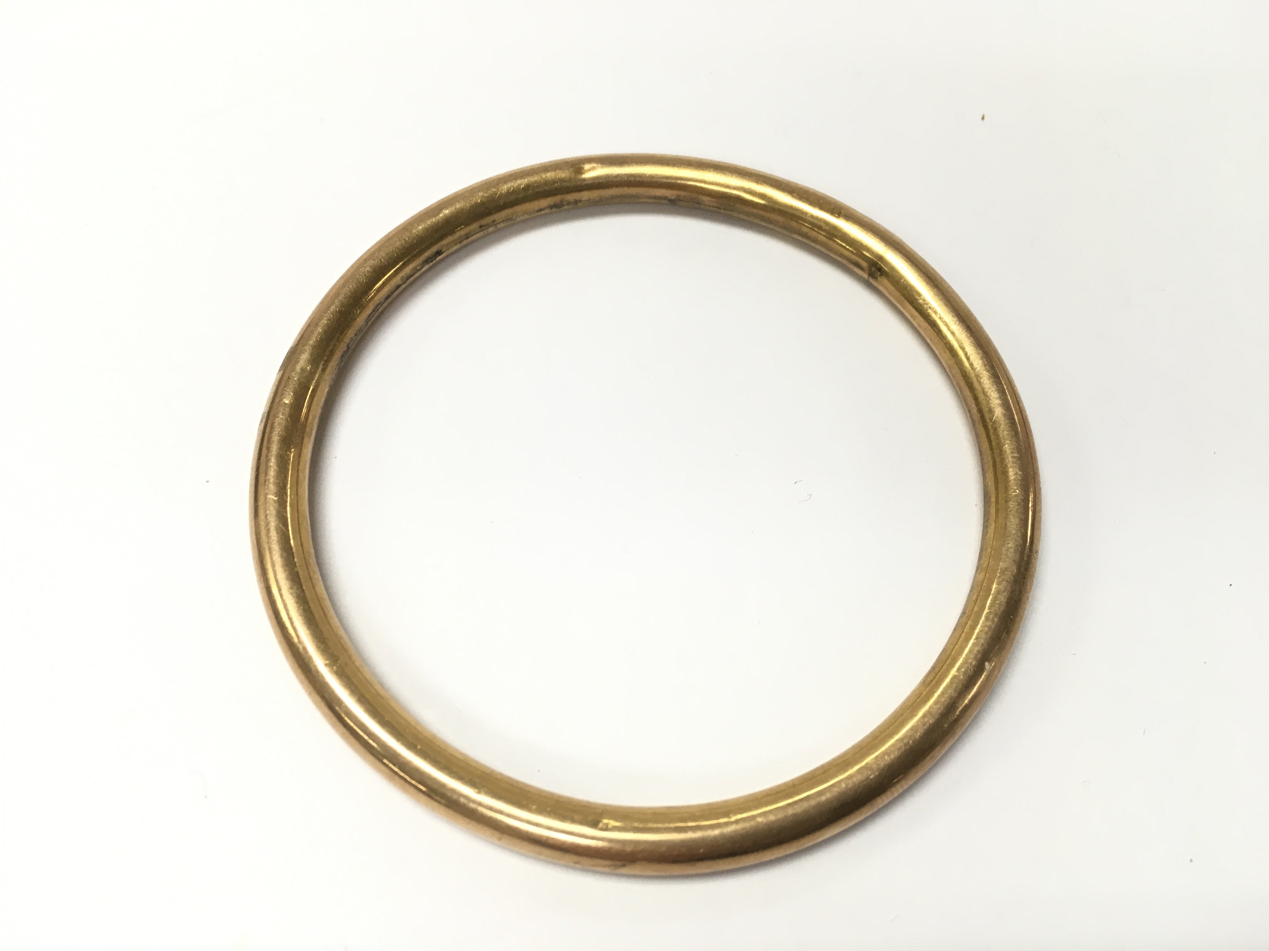 A 9ct gold bangle. 9cm diameter and 13.75g Postage A