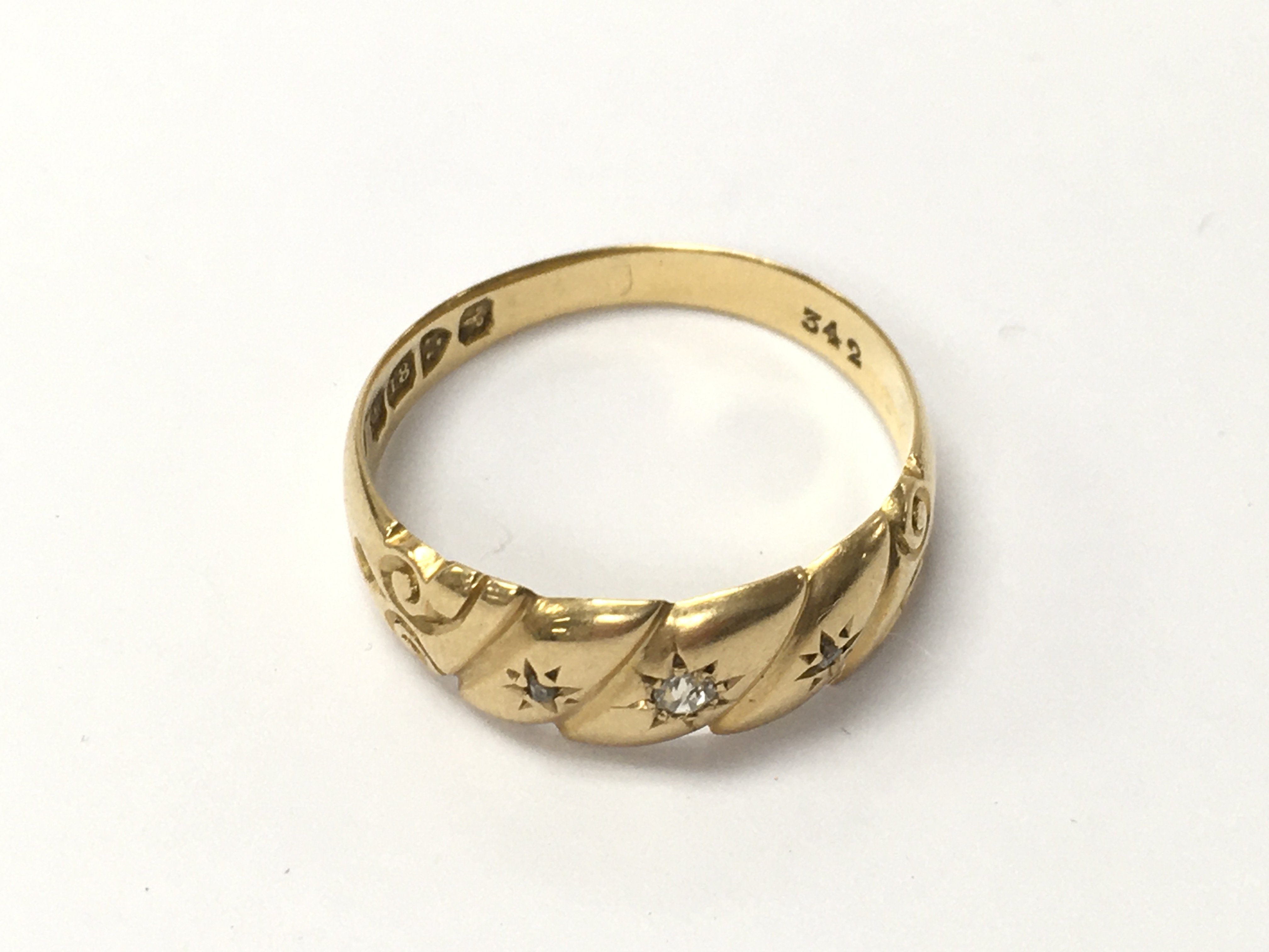 An 18ct gold ring set with small diamonds. Size Q 1/2 and 3.09g