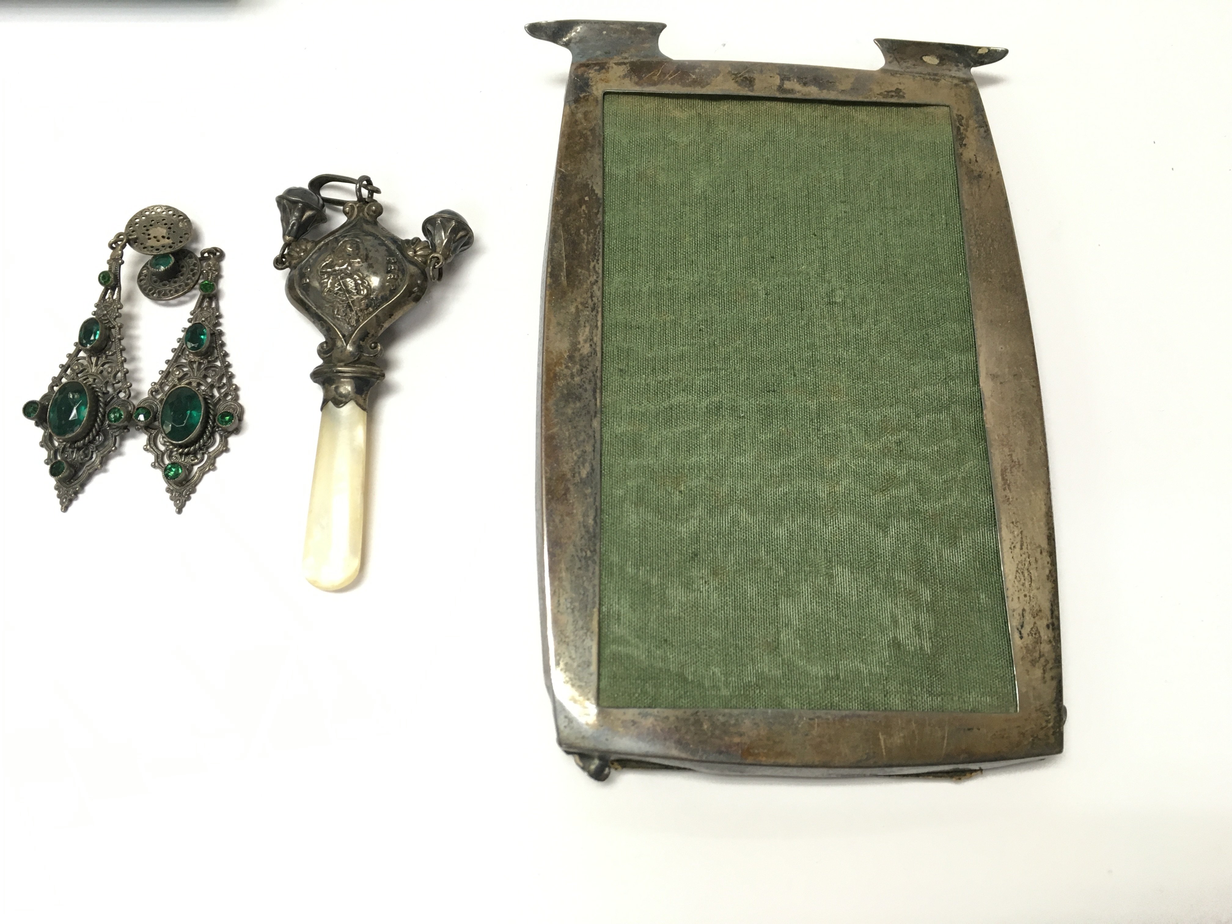 A silver picture frame and childs rattle and a pair of vintage dress earrings. Postage B