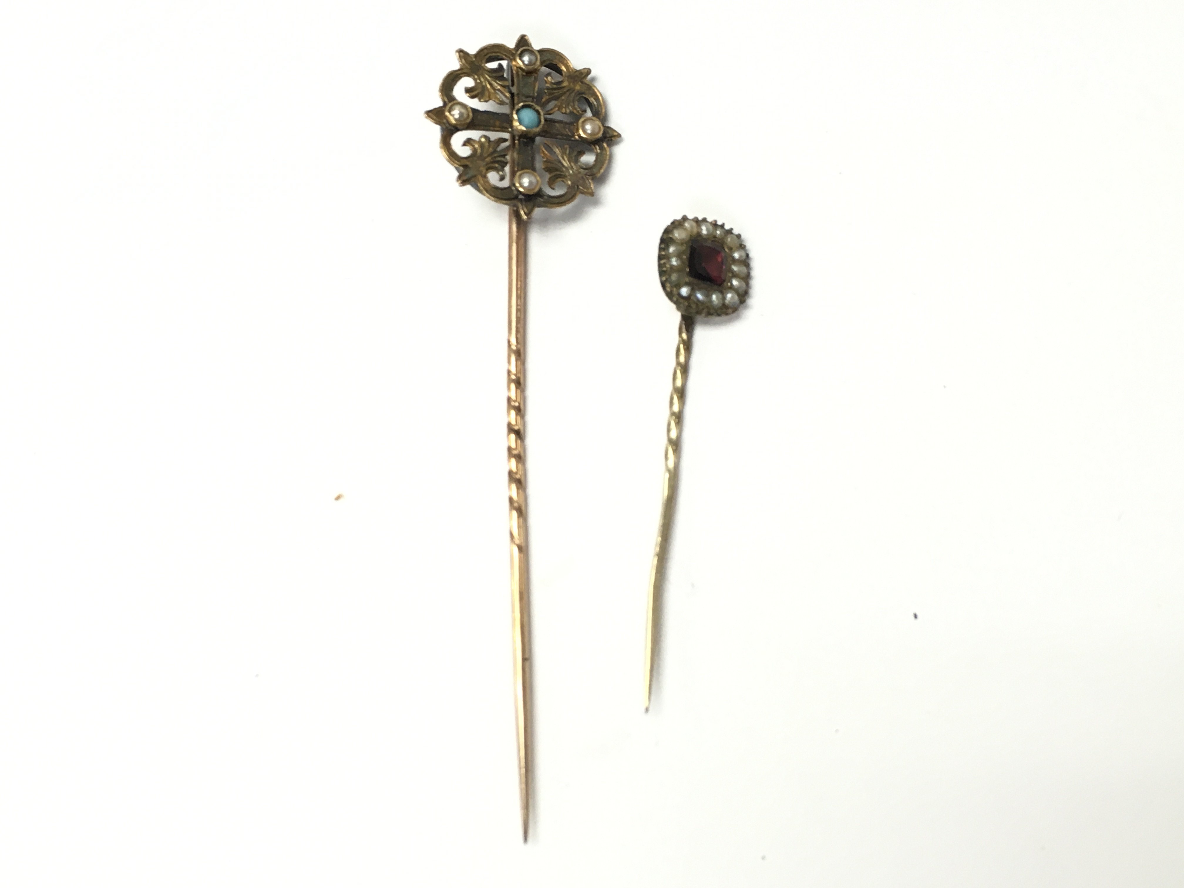 Two stick pins in a fitted case set with seed pearls. Postage A