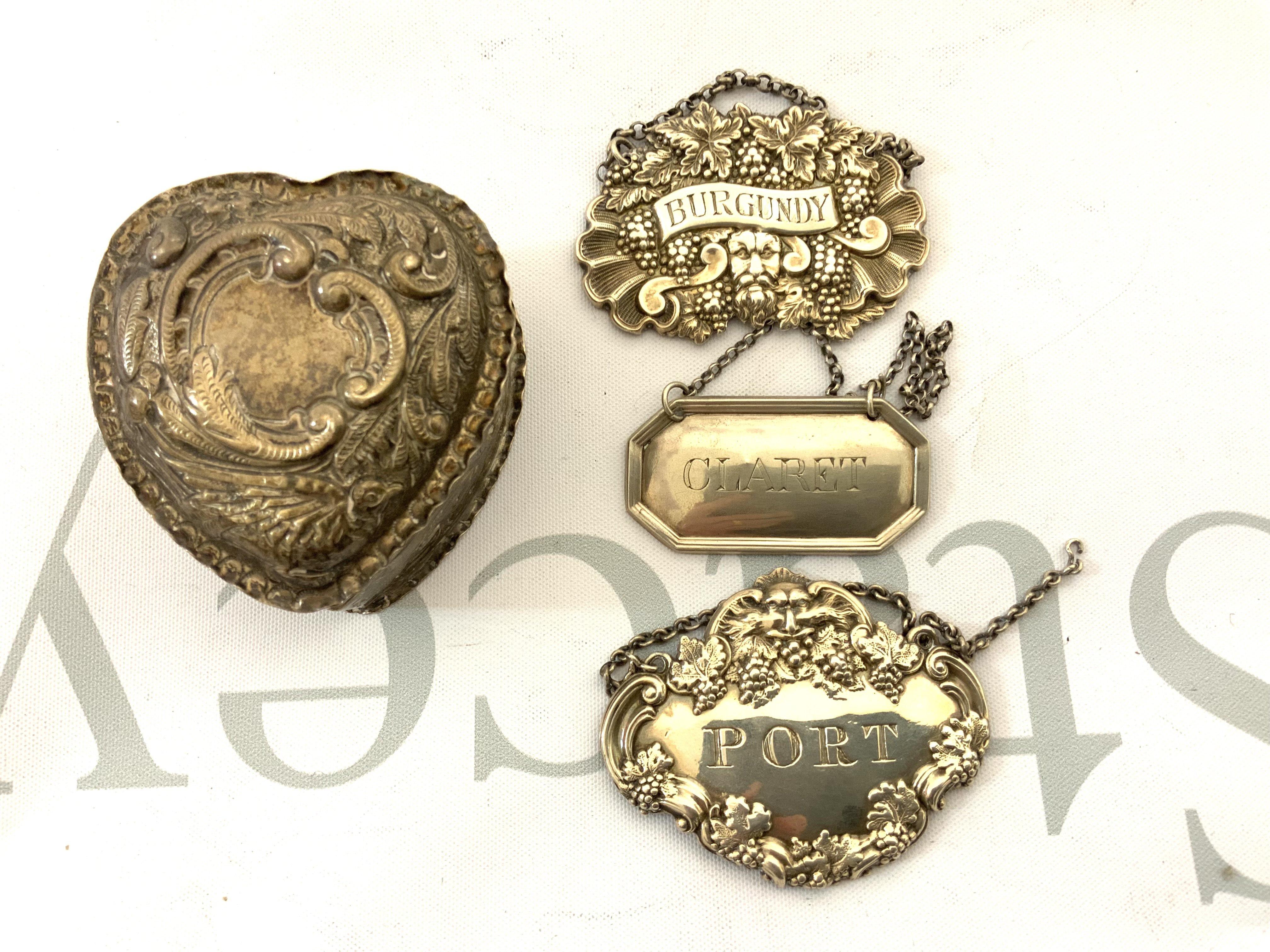 A small hallmarked silver heart shaped trinket box together with 3 good hallmarked silver wine labels (A)