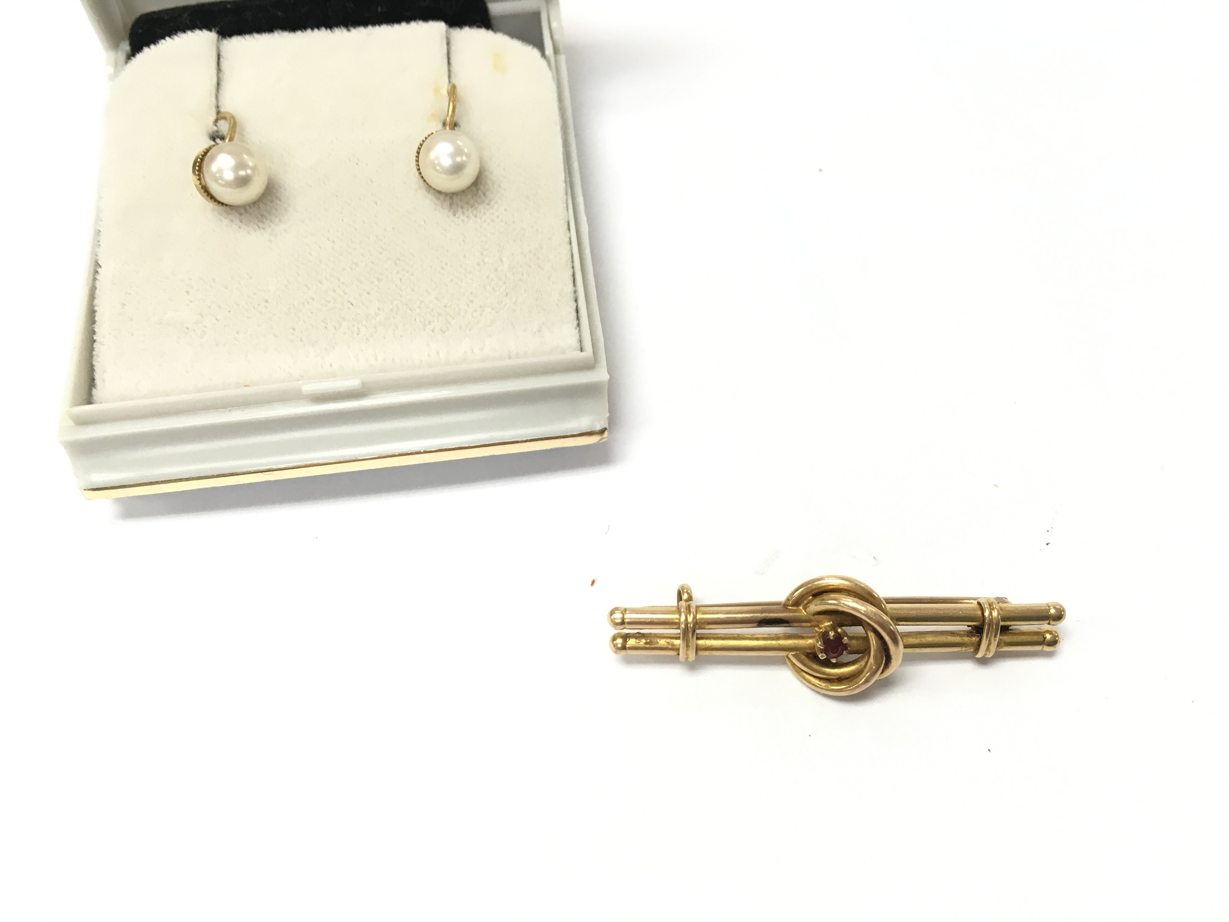 An 18ct gold brooch set with small ruby 2.87g and a pair of 9ct gold pearl earrings. Postage B