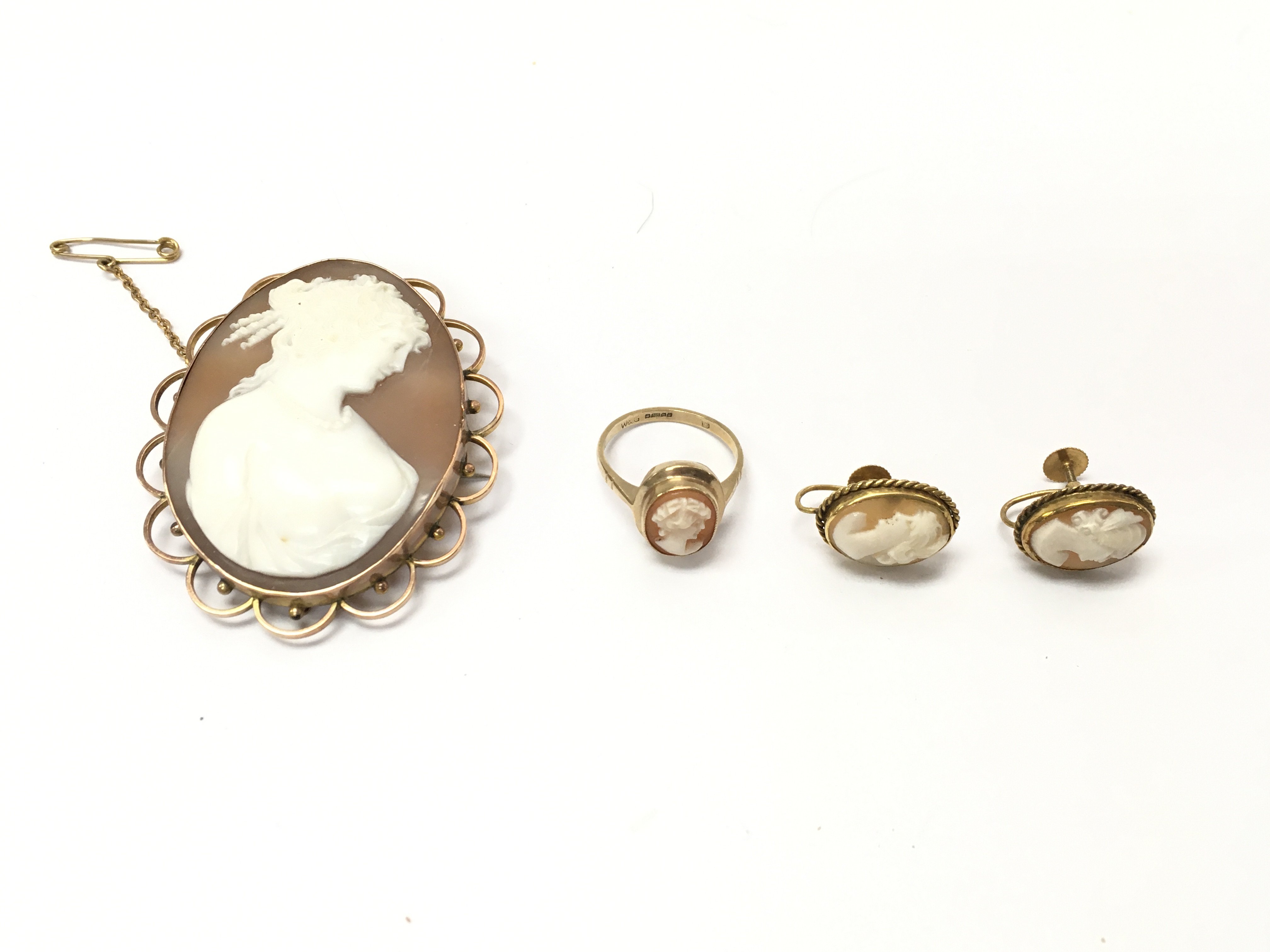 A 9ct gold cameo brooch earrings and ring. Postage B