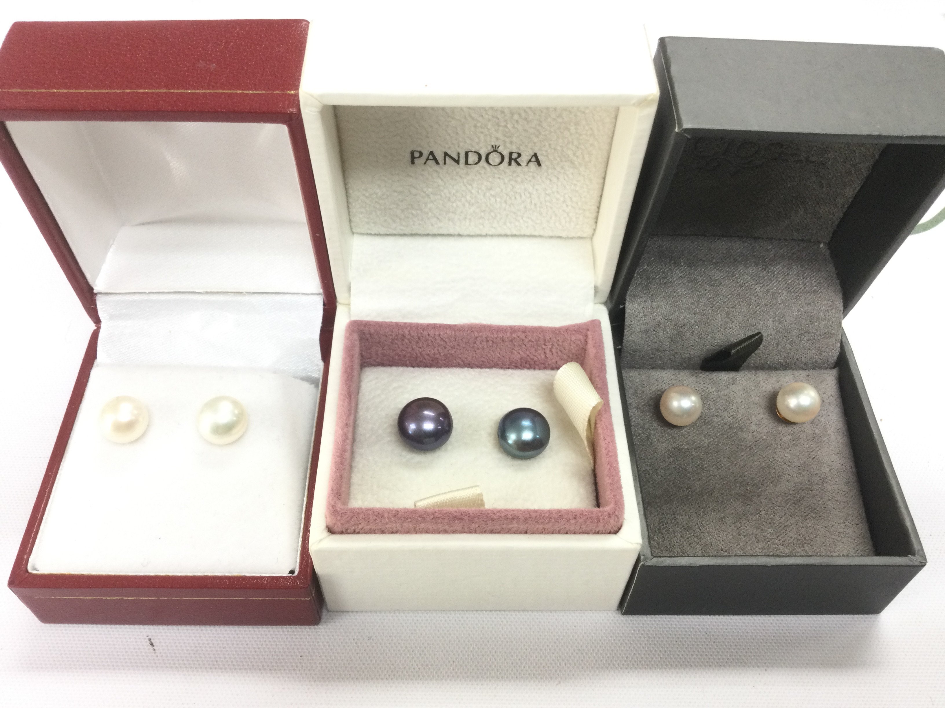 Three pairs of cultured pearl earrings. Shipping category A.