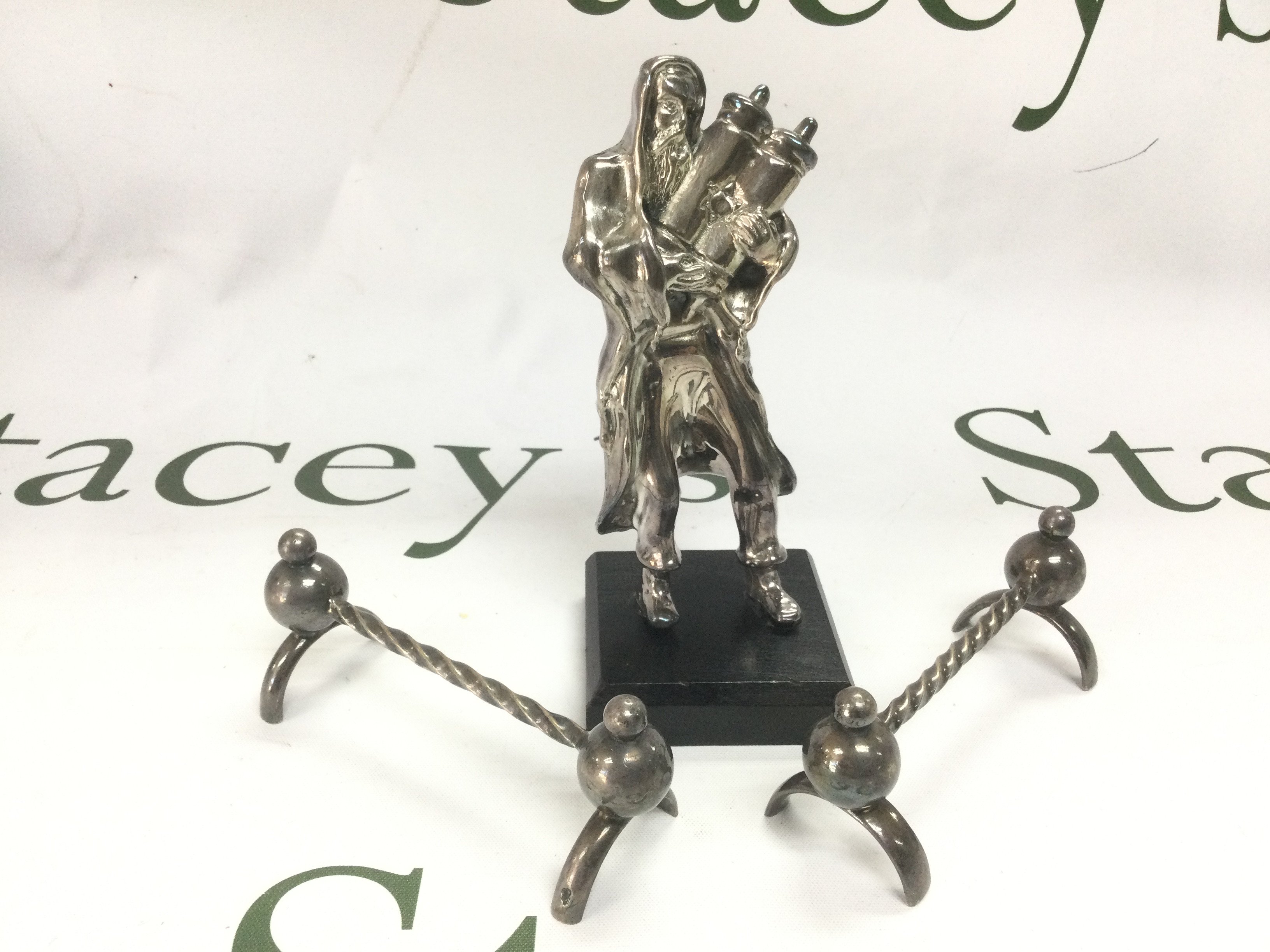 A silver plated judaica figure, approx height 14cm and a pair of silver plated knife rests (3). Shipping category B.