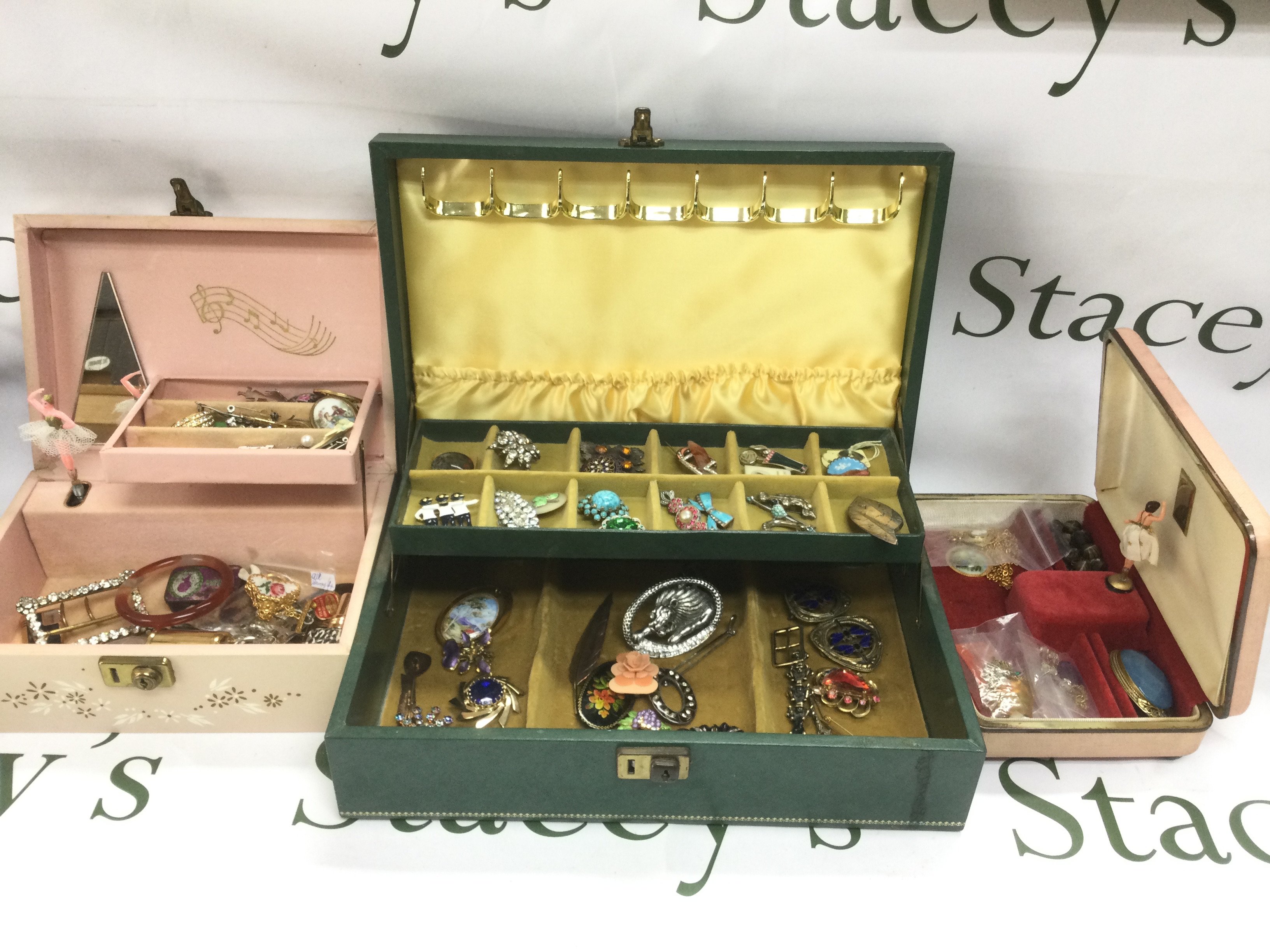 Three jewellery boxes containing various costume jewellery items. Shipping category C.