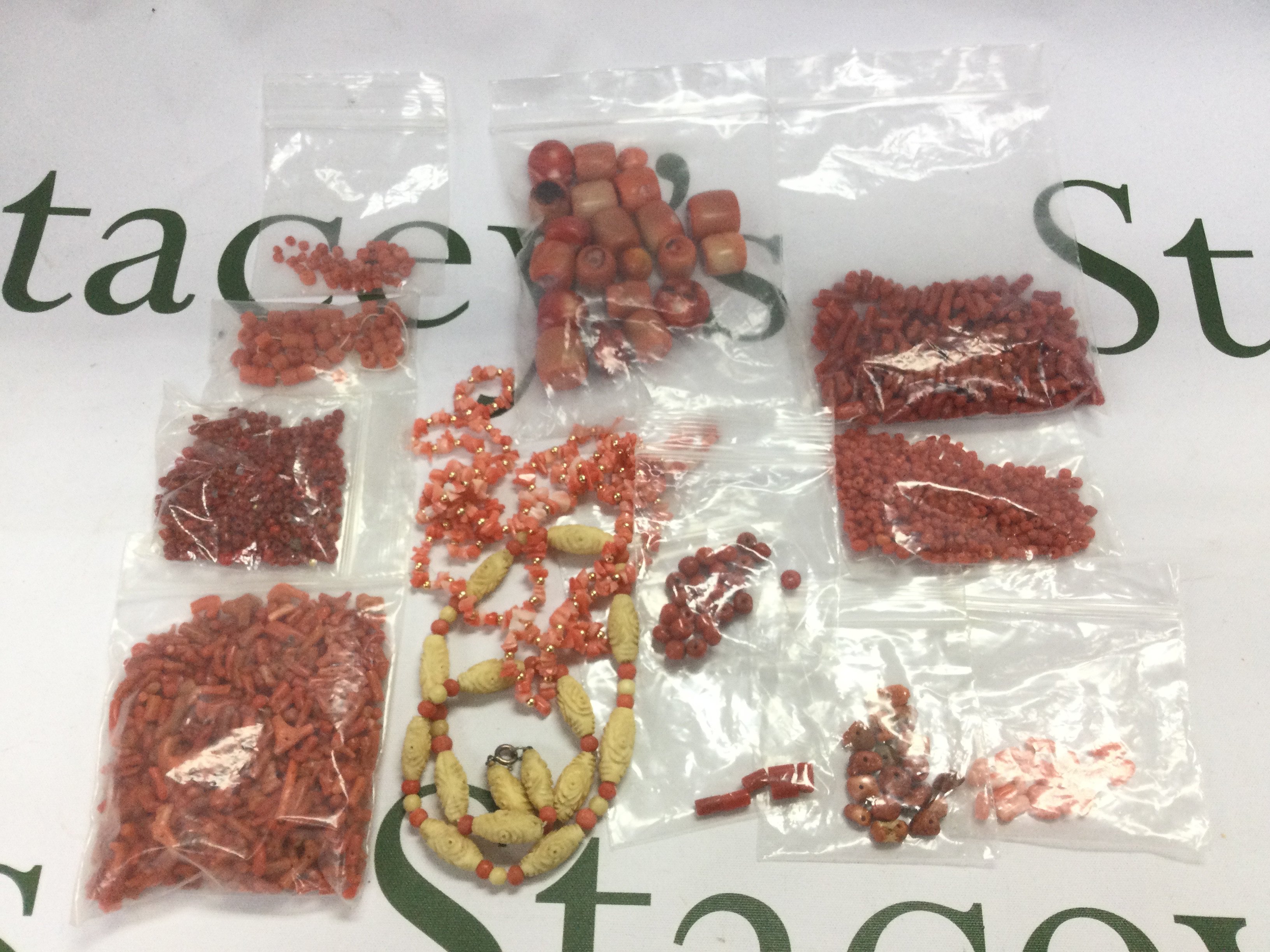 A collection of coral beads. Shipping category A.