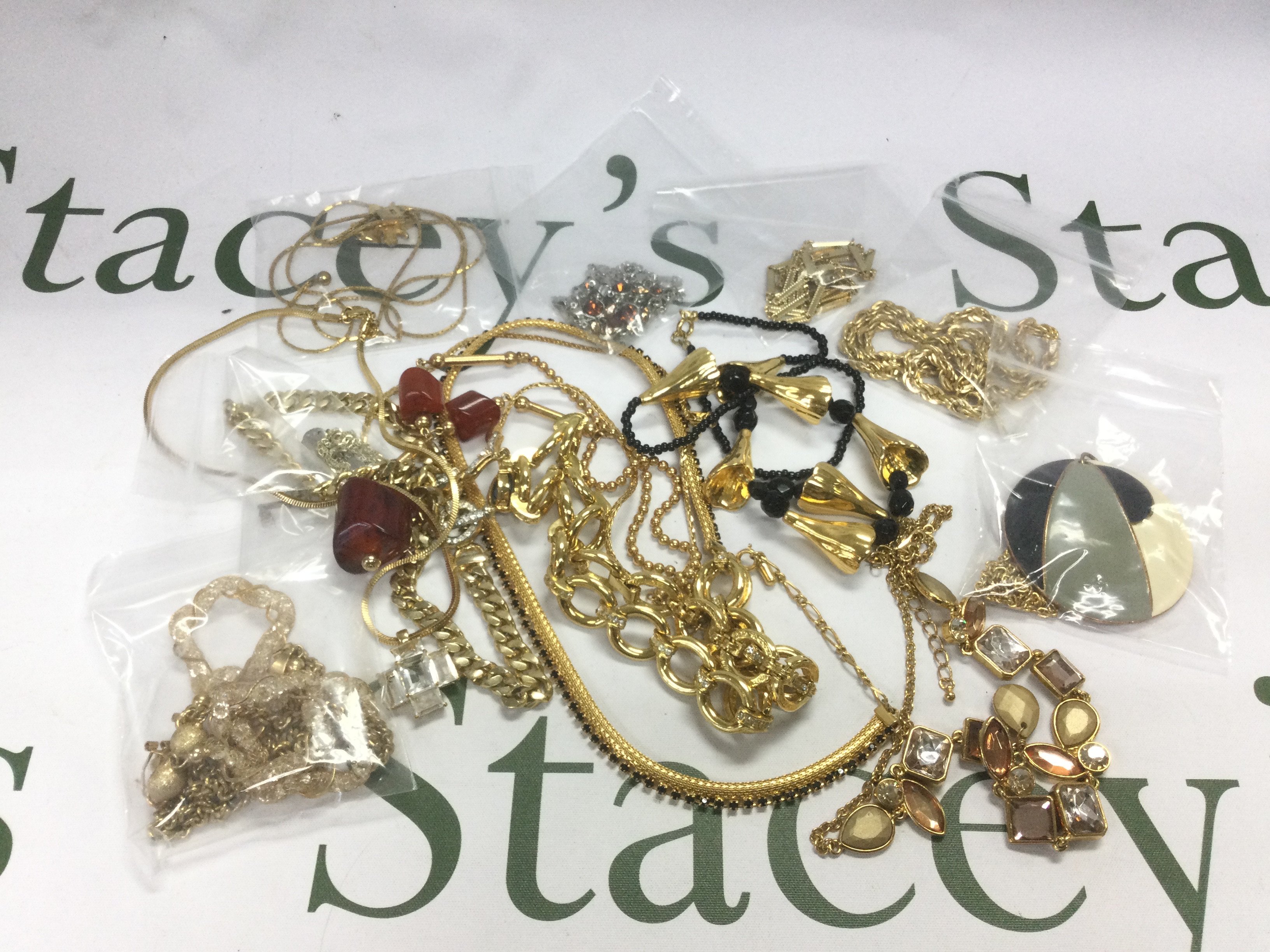 A collection of mainly gold tone necklaces. Shipping category A.
