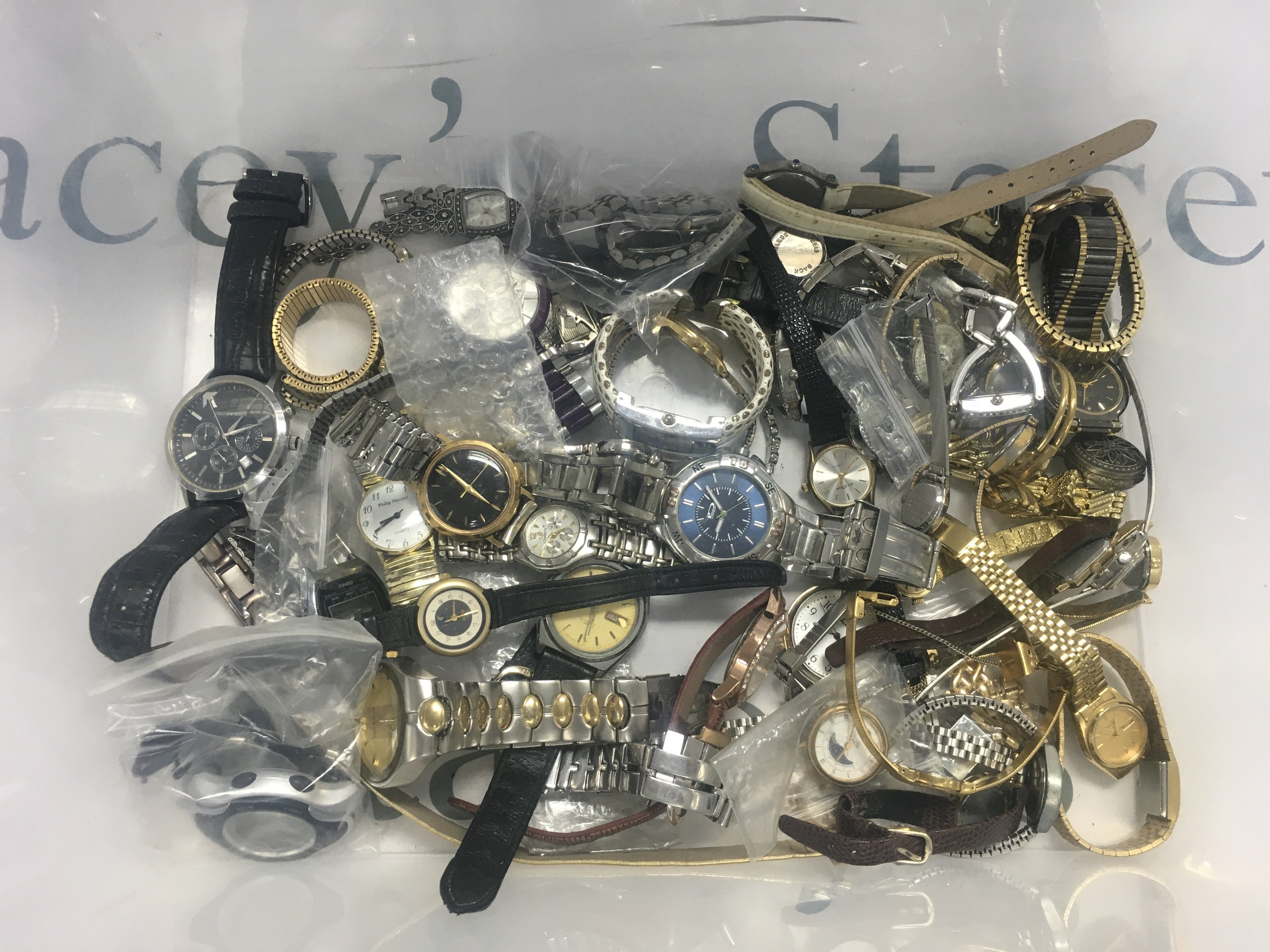 A plastic box of watches. Shipping category D.