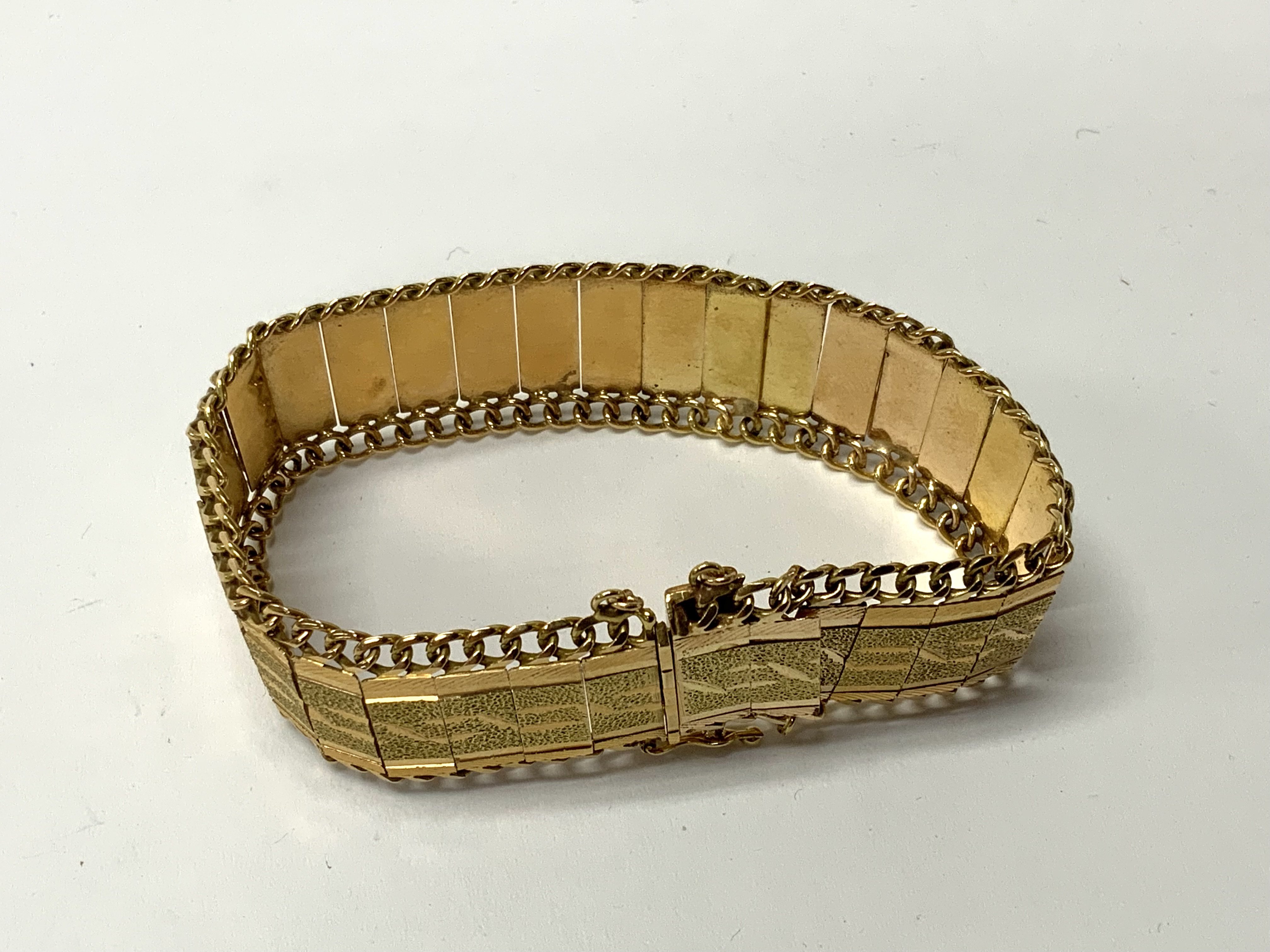 Circa1970s high carat gold bracelet, tested minimum 21ct, joined bar and chain design with etched panels. (A) total weight 34.68g.